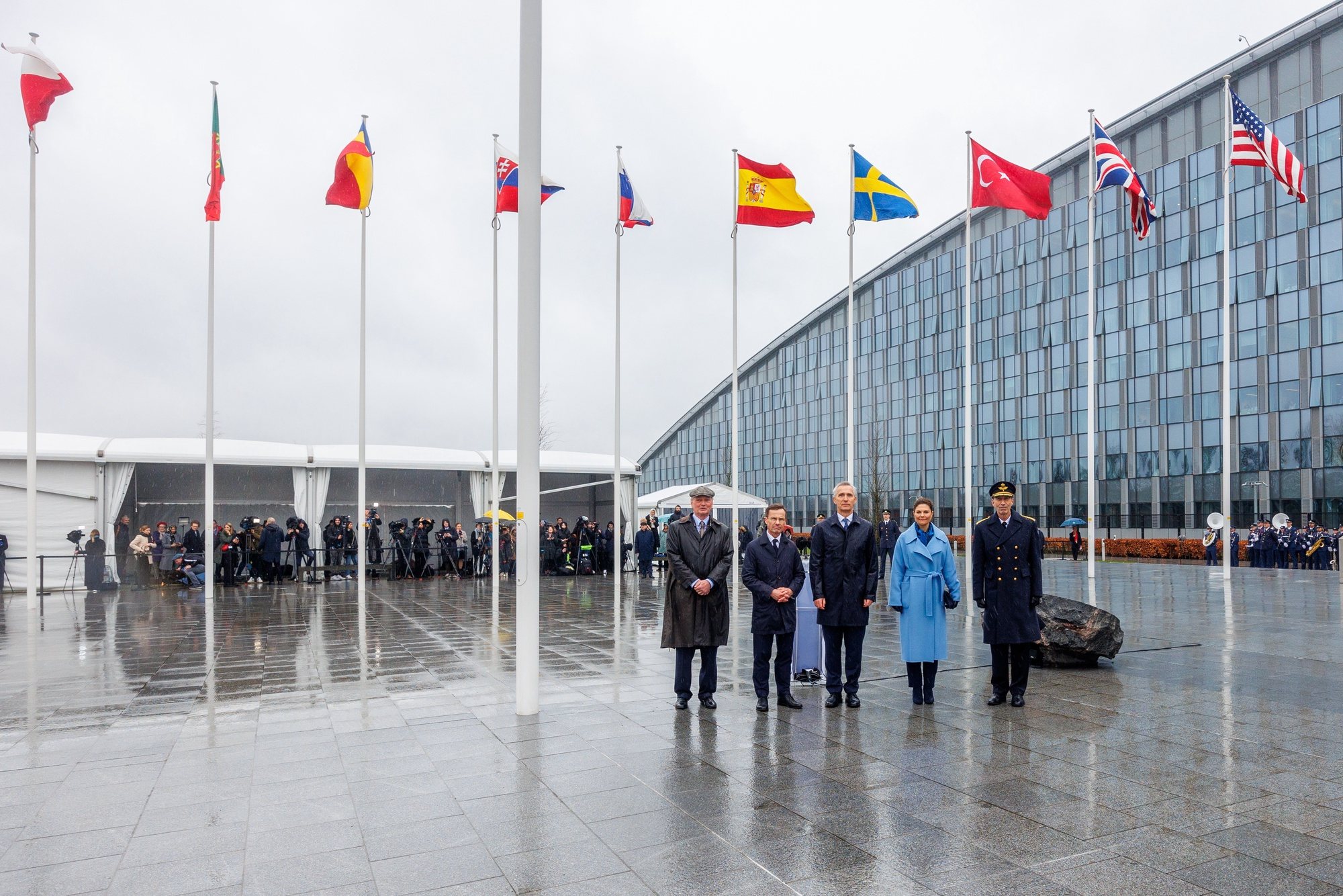 epa11214459 Crown Princess Victoria of Sweden, NATO Secretary General Jens Stoltenberg, and Swedish Prime Minister Ulf Kristersson attend the flag-raising ceremony to mark the accession of the Kingdom of Sweden to NATO at the Alliance headquarters in Brussels, Belgium, 11 March 2024.  EPA/OLIVIER MATTHYS