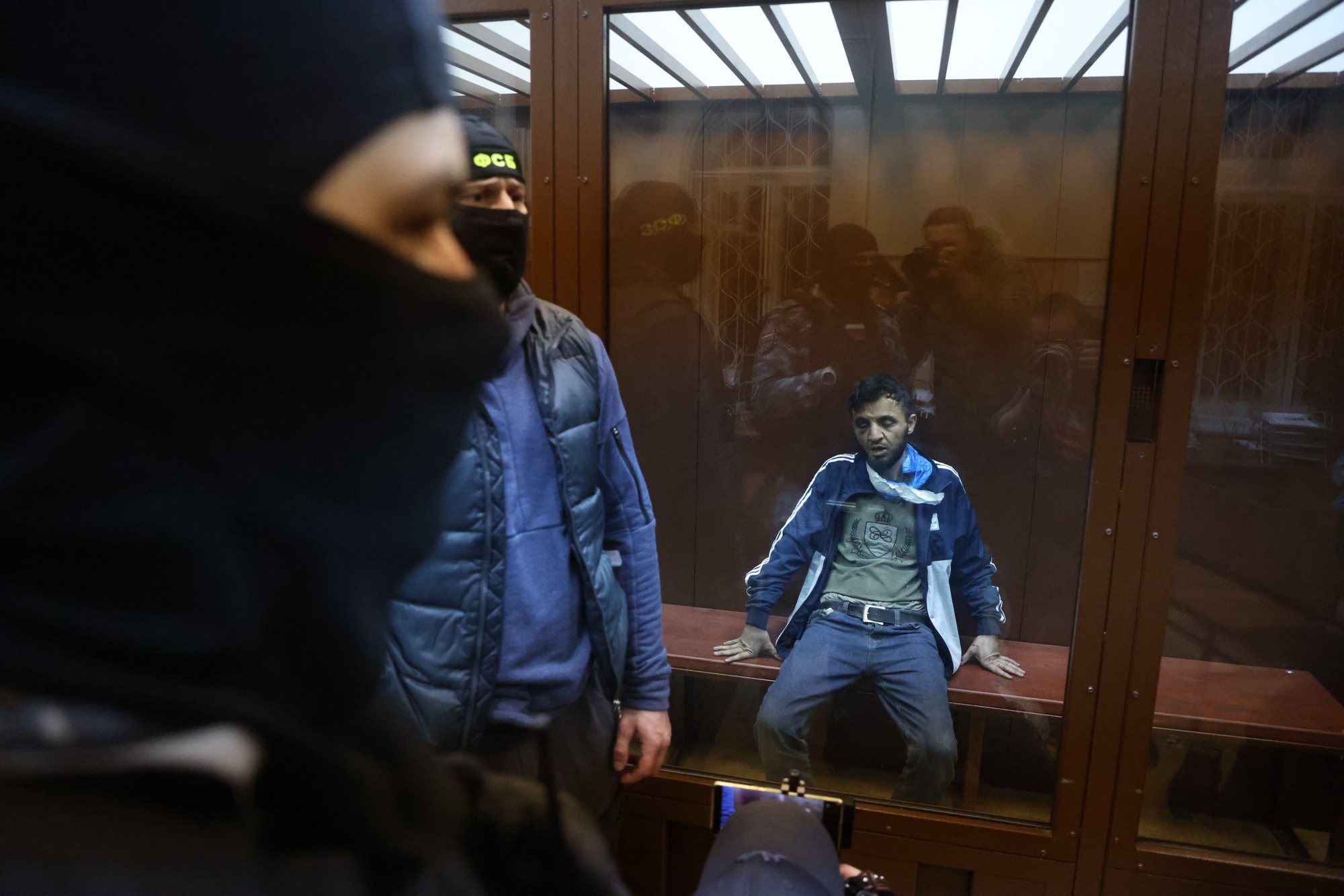 epa11241602 A suspect in the shooting attack on the Crocus City Hall concert venue sits inside a defendant&#039;s enclosure during a hearing on pretrial restrictions at Basmanny district court, in Moscow, Russia, 24 March 2024. At least 137 people were killed and more than 100 hospitalized after a group of gunmen attacked the concert hall in the Moscow region on 22 March evening, Russian officials said. Eleven suspects, including all four gunmen directly involved in the terrorist attack, have been detained, according to Russian authorities.  EPA/SERGEI ILNITSKY
