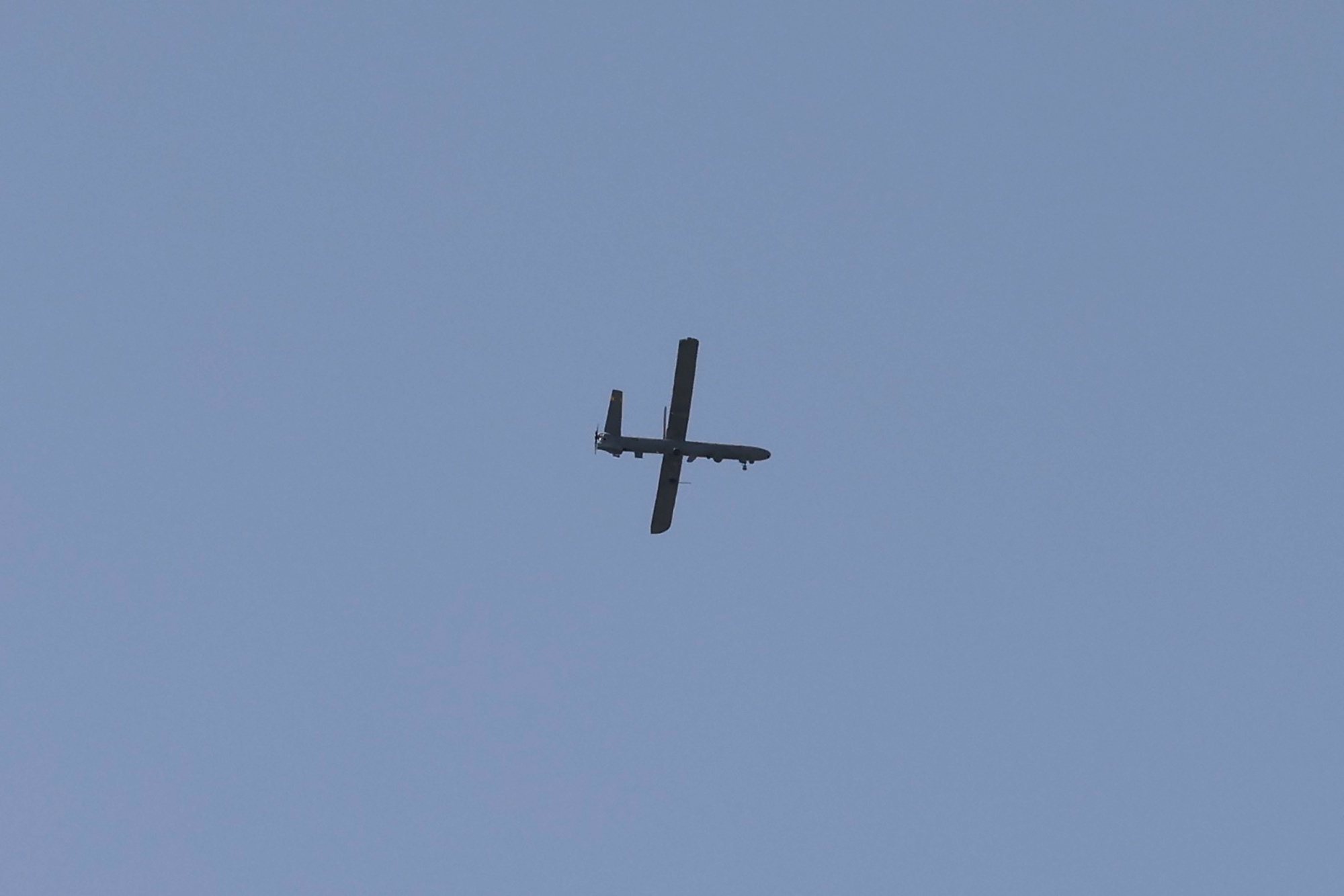 epa11244589 An Israeli unmanned aerial vehicle (UAV) flies over the border fence with the Gaza Strip, as seen from the Israeli side in southern Israel, 26 March 2024. More than 32,000 Palestinians and over 1,450 Israelis have been killed, according to the Palestinian Health Ministry and the Israel Defense Forces (IDF), since Hamas militants launched an attack against Israel from the Gaza Strip on 07 October 2023, and the Israeli operations in Gaza and the West Bank which followed it.  EPA/ABIR SULTAN