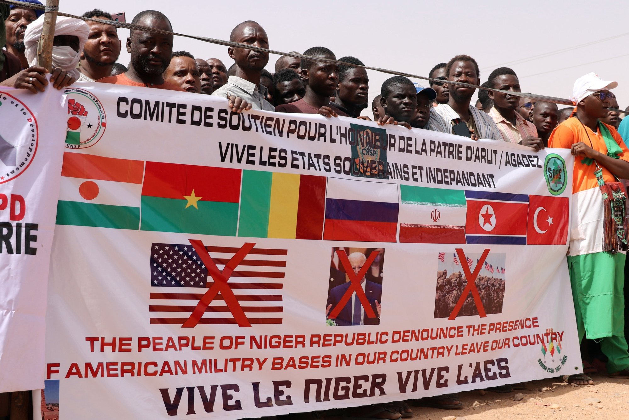epa11291930 Demonstrators hold a banner during a protest rally to demand the withdrawal of US troops from Niger, in Agadez, Niger, 21 April 2024. In March 2024, the ruling military junta revoked a military agreement with the US. Niger&#039;s decision to oust the US military out of the country follows France&#039;s withdrawal of its forces from Niger last year.  EPA/ISSIFOU DJIBO