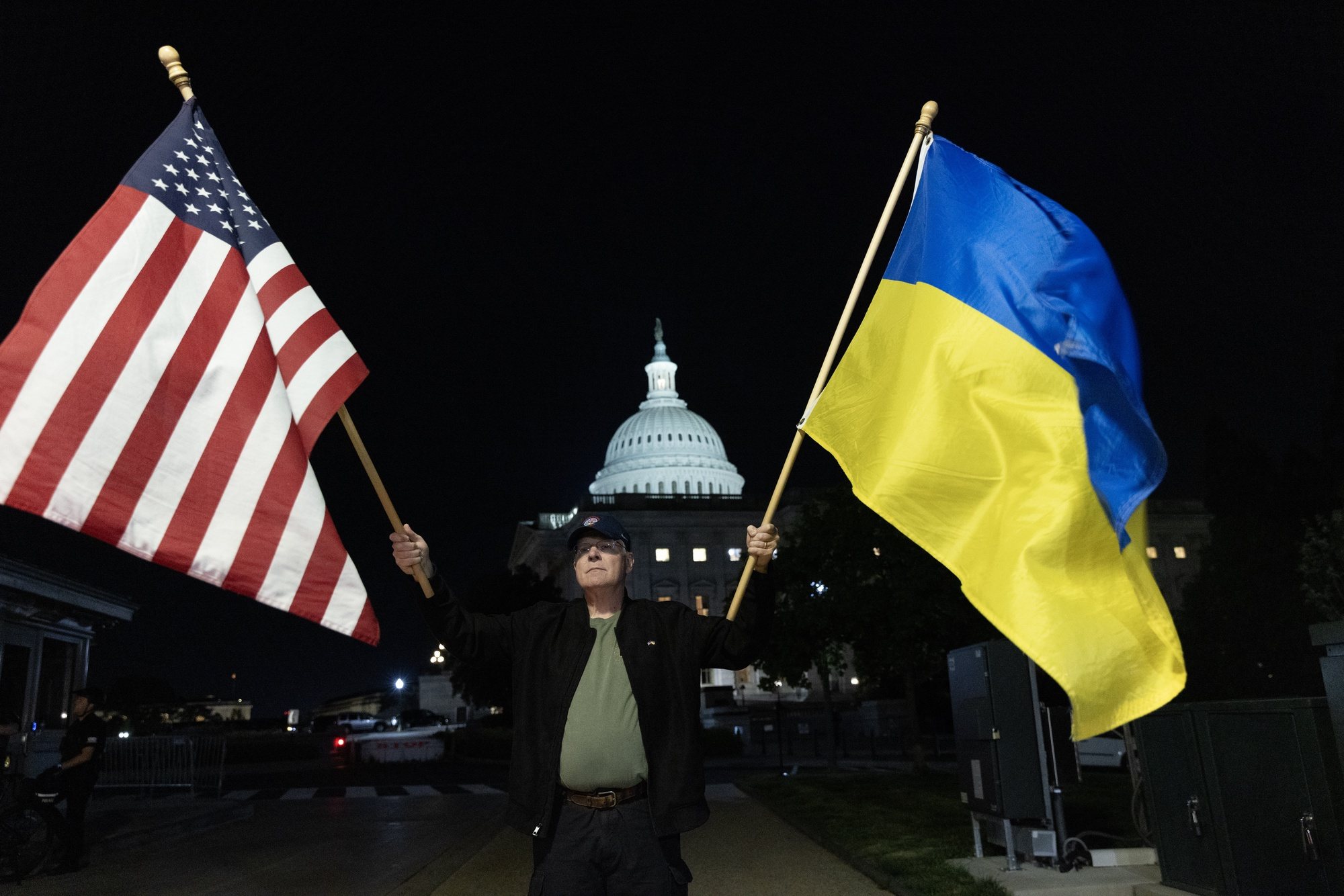 epa11296773 Supporters of Ukraine hold flags outside the US Capitol Building after the Senate passed the 95 billion USD national security supplemental that includes aid to Israel, Ukraine and Taiwan on Capitol Hill in Washington, DC, USA, 23 April 2024.  EPA/MICHAEL REYNOLDS