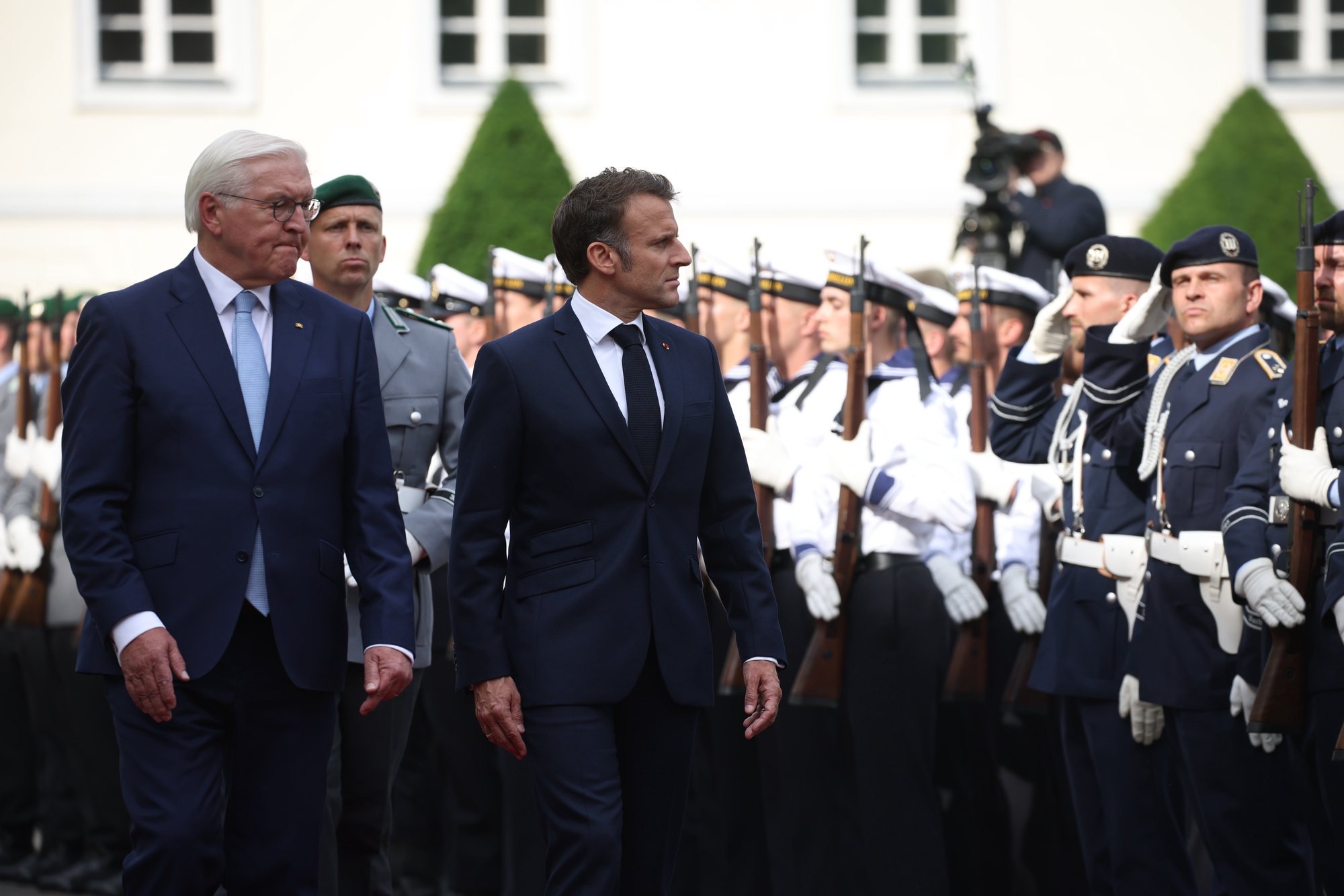 epa11371618 German President Frank-Walter Steinmeier (L) and French President Emmanuel Macron (3-L) walk next to each other during a reception with with military honors at Bellevue Palace in Berlin, Germany, 26 May 2024. Macron visits Germany from 26 to 28 May. The French President and Federal President Steinmeier will visit several regions of Germany together. It is the first state visit - the highest form of visit in diplomatic protocol - by a French president to Germany in 24 years.  EPA/CLEMENS BILAN