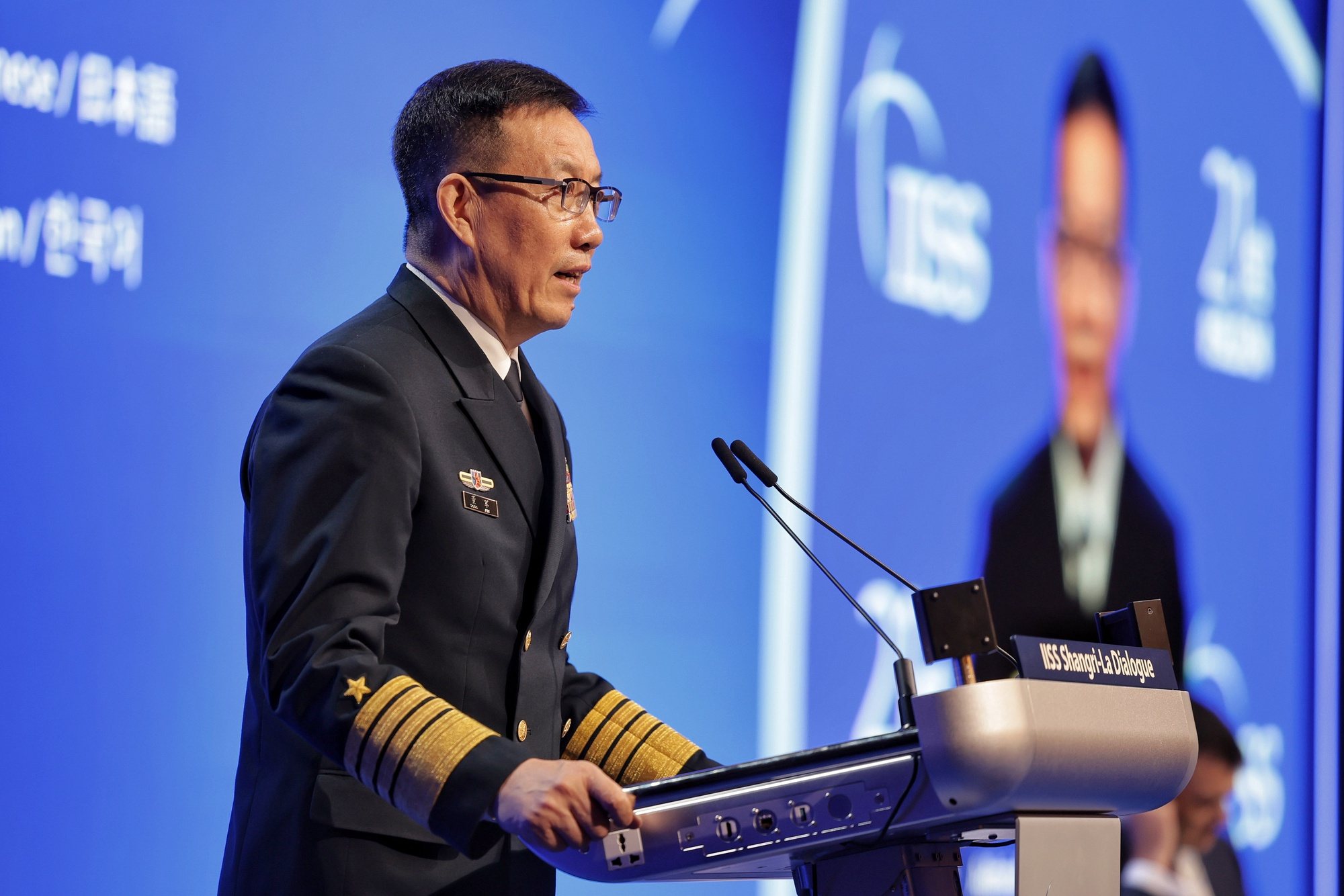 epa11384962 China&#039;s Minister of National Defence Admiral Dong Jun delivers his speech during a plenary session of the International Institute for Strategic Studies (IISS) 21th Shangri-La Dialogue in Singapore, 02 June 2024. Defense ministers and officials from 45 countries are gathered in the city state for the IISS Shangri-la Dialogue, an annual high level defence summit in the Asia Pacific region.  EPA/KEVIN LIM/THE STRAITS TIMES SINGAPORE OUT HANDOUT EDITORIAL USE ONLY/NO SALES HANDOUT EDITORIAL USE ONLY/NO SALES