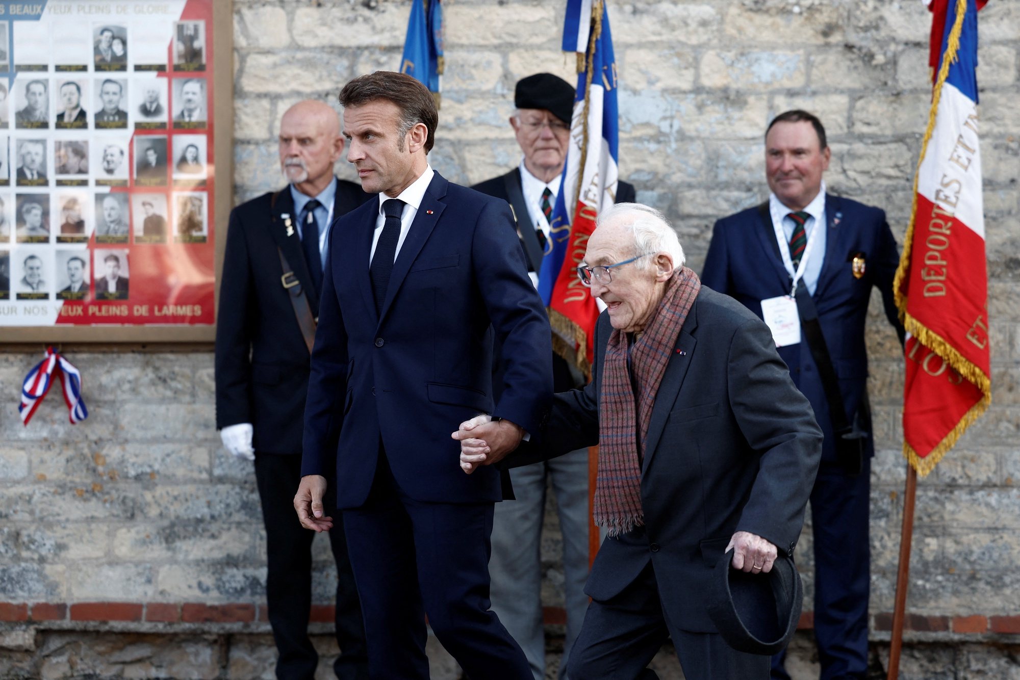 epa11391884 French President Emmanuel Macron holds the hand of Bernard Duval, a survivor of the 1944 Caen prison massacre, during a ceremony at the Caen prison to pay tribute to French Resistance fighters in Caen, north-western France, 05 June 2024. French President Macron launched the commemoration of the 80th anniversary of D-Day, the Normandy landings of Western Allied forces on 06 June 1944 that initiated the liberation of western Europe during World War II, by paying tribute to the French Resistance fighters.  EPA/BENOIT TESSIER / POOL  MAXPPP OUT