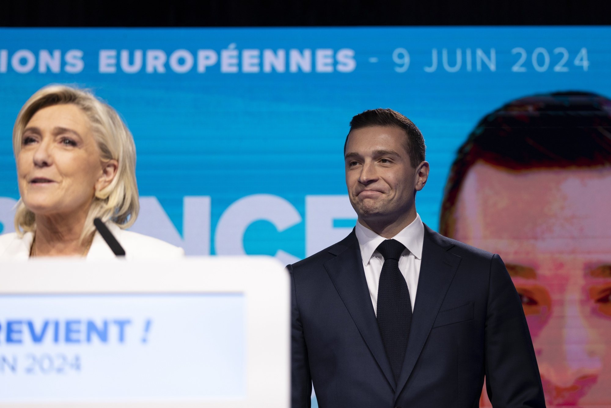 epa11400774 National Rally leader Jordan Bardella (R) reacts as parliamentary party leader Marine Le Pen (L) delivers a speech at the electoral party of the French right-wing party National Rally (Rassemblement National or RN) in Paris, France, 09 June 2024, after the first results of the European elections. The list of the Rassemblement National, led by party chief Jordan Bardella, is given winner in France according to first estimations after polls.  EPA/ANDRE PAIN