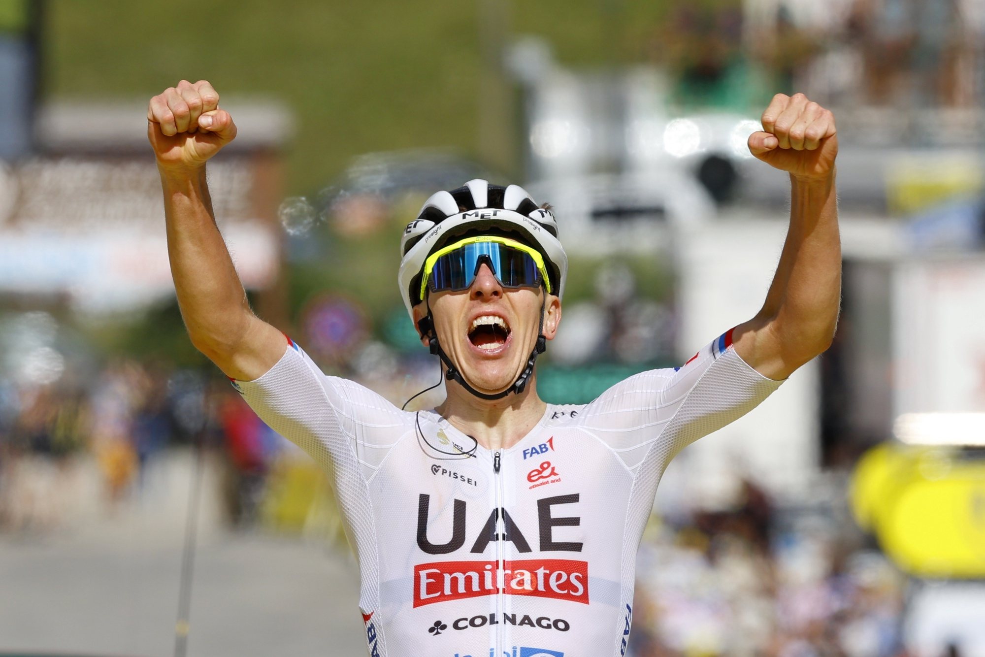 epa11452543 Slovenian rider Tadej Pogacar of UAE Team Emirates celebrates as he crosses the finish line to win the fourth stage of the 2024 Tour de France cycling race over 139km from Pinerolo to Valloire, France, 02 July 2024.  EPA/KIM LUDBROOK