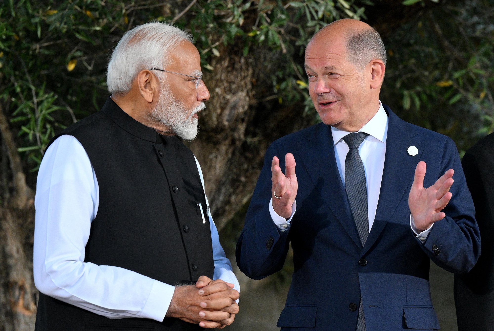 epa11410438 German Chancellor Olaf Scholz (R) speaks with Indian Prime Minister Narendra Modi (L) before posing for a group photo with G7 heads of states and the heads of delegation of outreach countries during the second day of the G7 Summit in Borgo Egnazia, Italy, 14 June 2024. The 50th G7 summit brings together the Group of Seven member states leaders in Borgo Egnazia resort in southern Italy from 13 to 15 June 2024.  EPA/ETTORE FERRARI