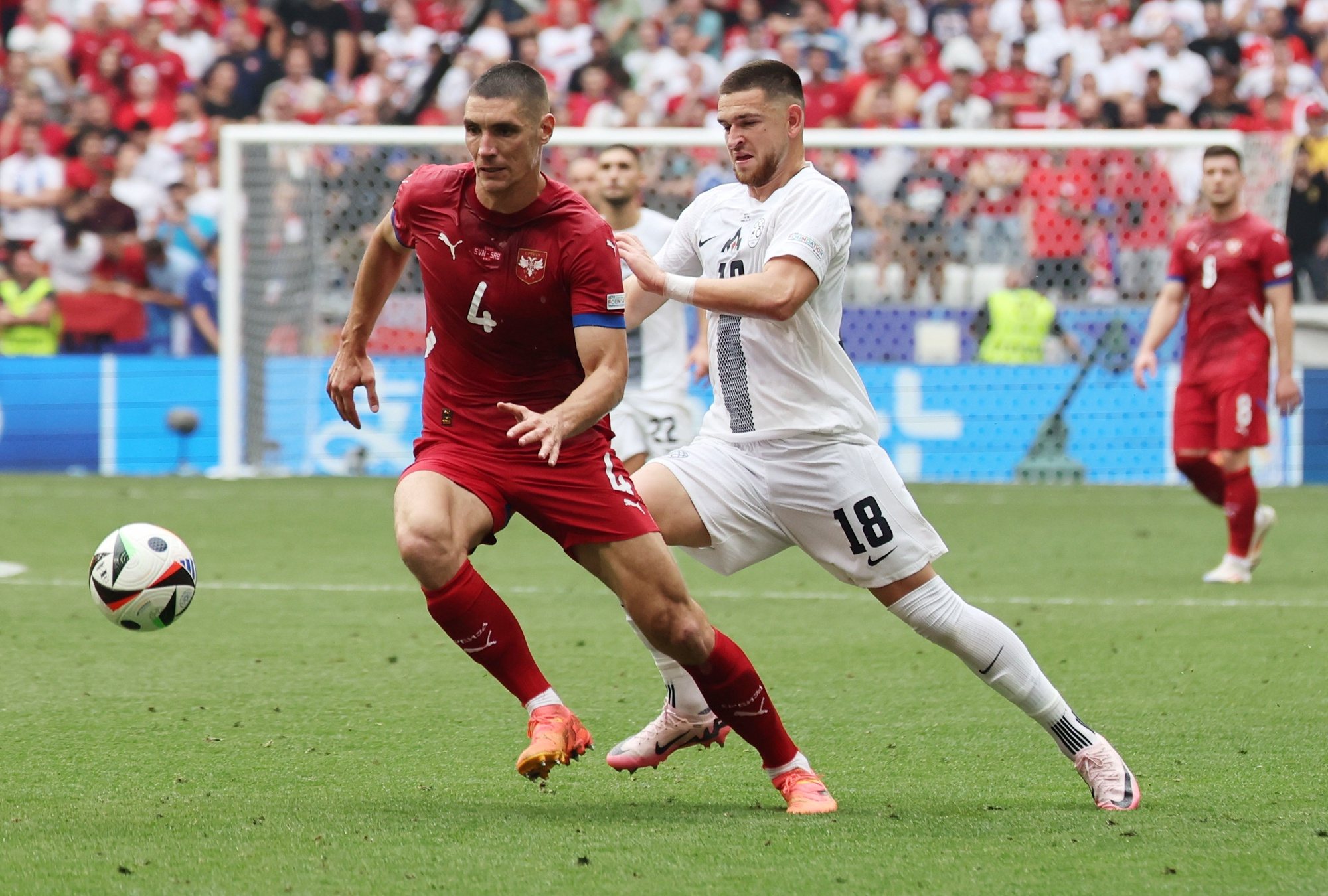 epa11425497 Nikola Milenkovic of Serbia (L) and Zan Vipotnik of Slovenia (R) in action during the UEFA EURO 2024 Group C soccer match between Slovenia and Serbia, in Munich, Germany, 20 June 2024.  EPA/MOHAMED MESSARA