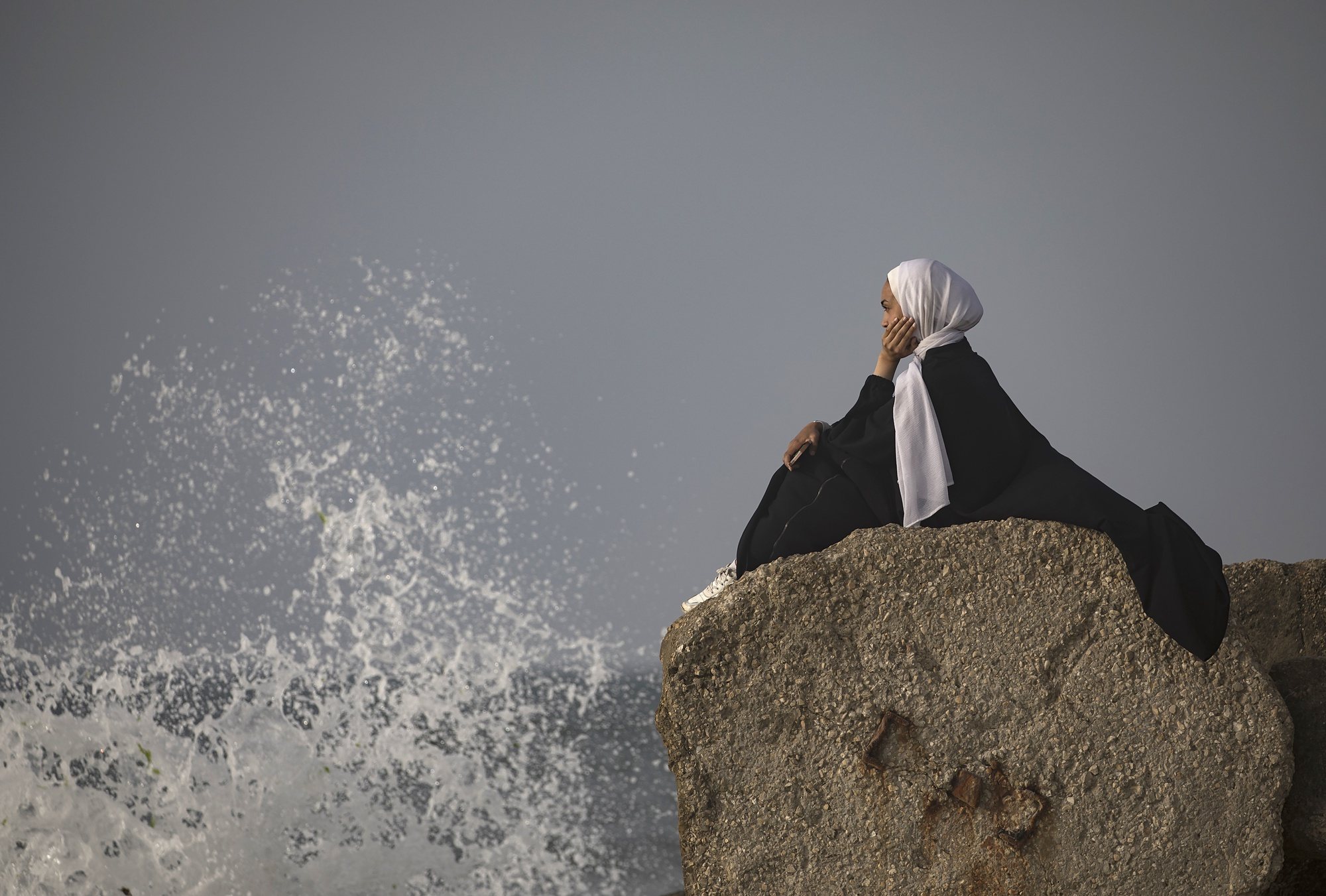 epa11287019 A displaced Palestinian woman sitting on a rock by the sea, at the beach near Rafah refugee camp, southern Gaza Strip, 18 April 2024. Since 07 October 2023, up to 1.7 million people, or more than 75 percent of the population, have been displaced throughout the Gaza Strip, some more than once, as they search of safety, according to the United Nations Relief and Works Agency for Palestine Refugees in the Near East (UNRWA), which added that the Palestinian enclave is &#039;on the brink of famine&#039;, with 1.1 million people (half of its population) &#039;experiencing catastrophic food insecurity&#039; due to the conflict and restrictions on humanitarian access.  EPA/HAITHAM IMAD