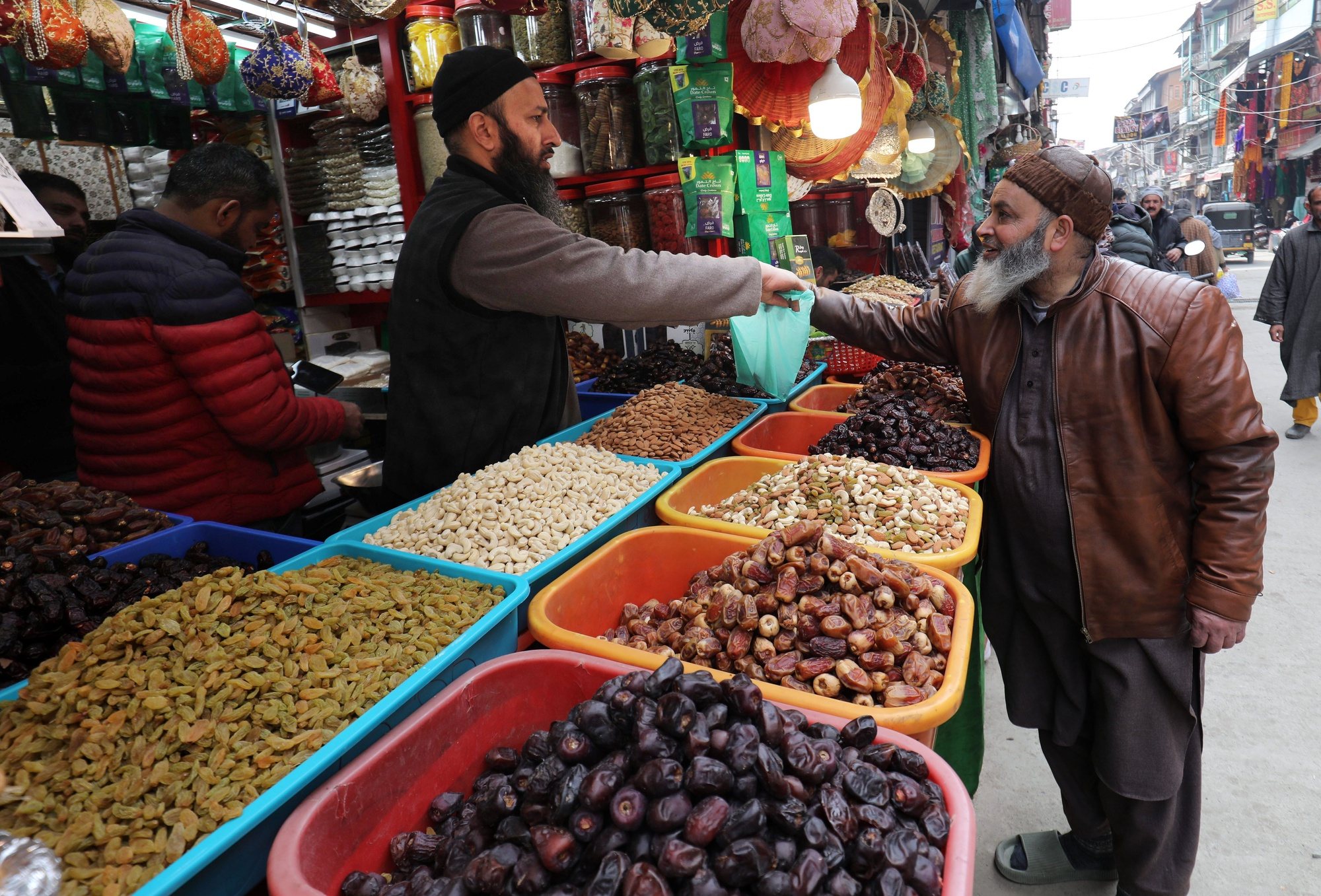 epa11214005 A Kashmiri Muslim man buys dry fruits ahead of the holy fasting month of Ramadan in Srinagar, the summer capital of Indian Kashmir, 11 March 2024. The Muslims&#039; holy month of Ramadan, which is expected to start on 12 March in Kashmir, is the ninth month in the Islamic calendar, and it is believed that the revelation of the first verse in the Koran was during its last 10 nights. It is celebrated yearly by praying during the night and abstaining from eating, drinking, and sexual acts during the period between sunrise and sunset. It is also a time for socializing, mainly in the evening after breaking the fast, and a shift of all activities to late in the day in most countries.  EPA/FAROOQ KHAN