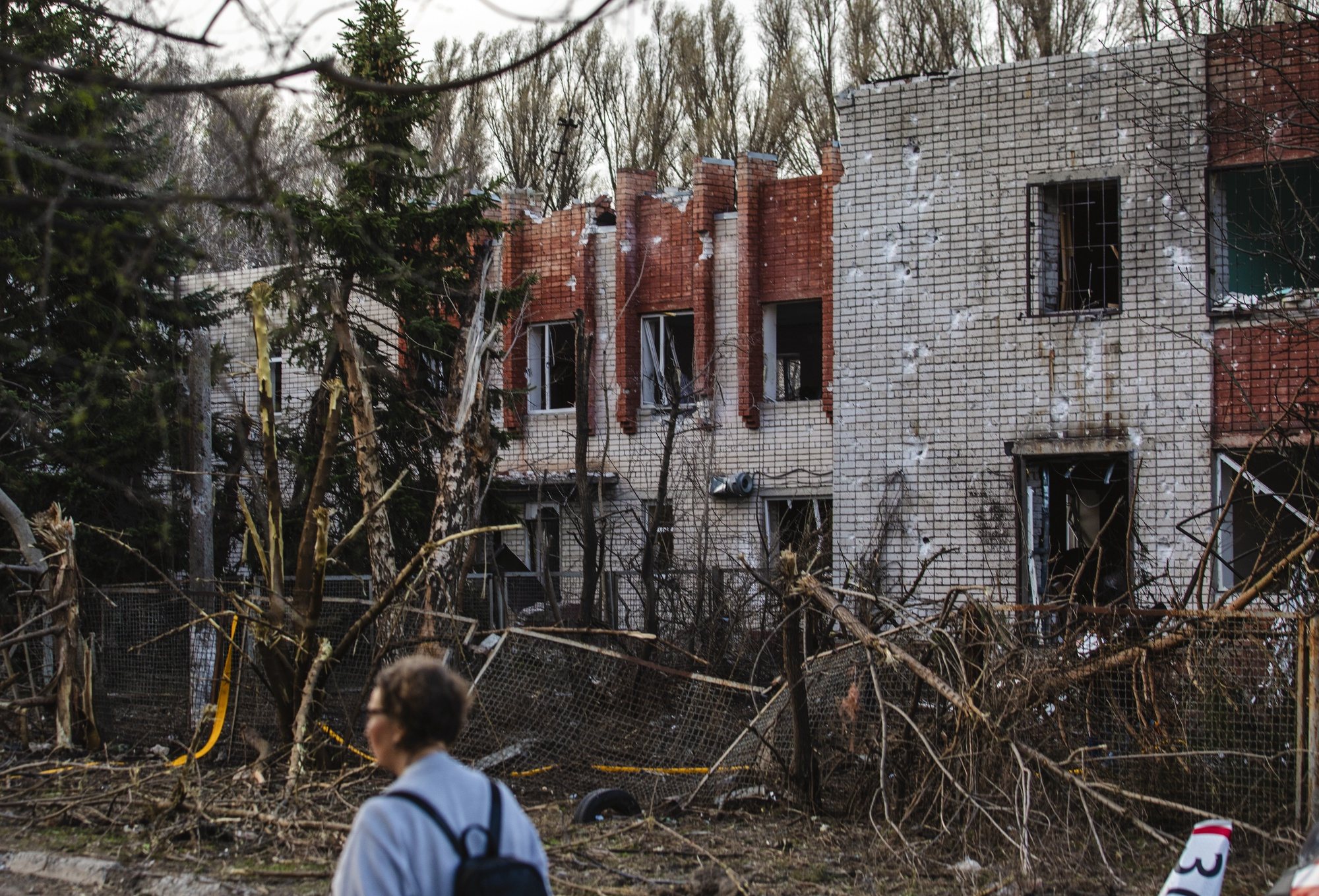 epa11255784 A woman walks past the site of a rocket attack on a kindergarten in the city of Dnipro, Dnipropetrovsk region, southeastern Ukraine, 02 April 2024, amid the Russian invasion. At least 13 people were injured in Dnipro, including five children, as a result of the rocket attack on an educational institution and kindergarten building, according to the State Emergency Service.  EPA/ARSEN DZODZAIEV 48547