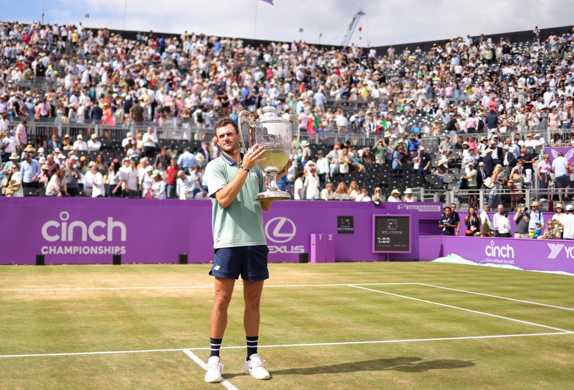 epa11432286 Tommy Paul of USA celebrates with the trophy after winning his final against Lorenzo Musetti of Italy at the Queen&#039;s Club tennis tournament in London, Britain, 23 June 2024.  EPA/NEIL HALL