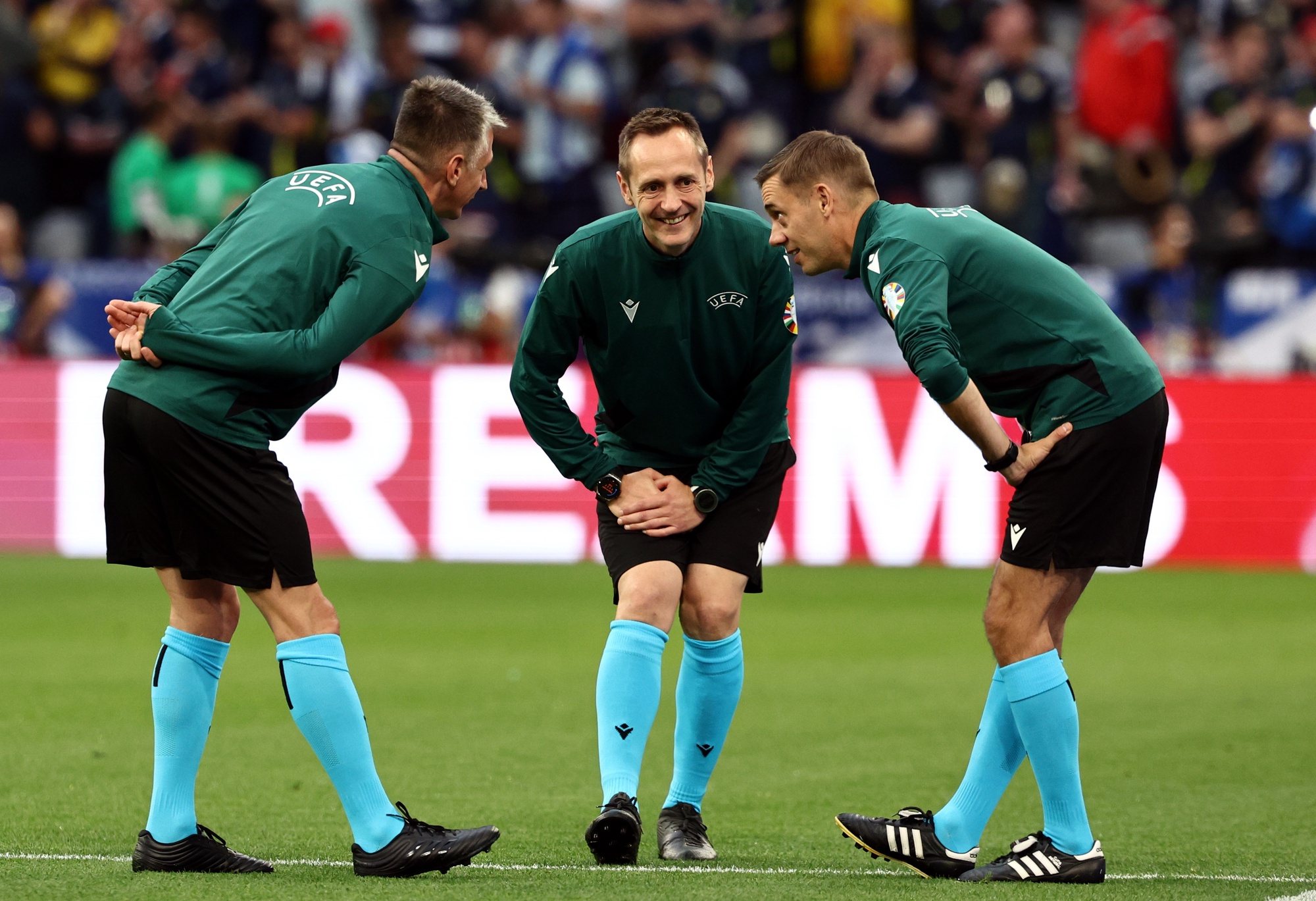 epa11410450 French referee Clement Turpin (R) warms up with his team prior to the UEFA EURO 2024 group A match between Germany and Scotland in Munich, Germany, 14 June 2024.  EPA/ANNA SZILAGYI