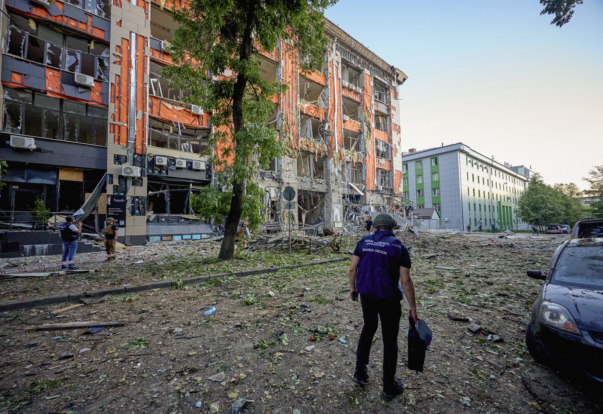epa11370064 A war crimes prosecutor works at the site of shelling of a residential area in Kharkiv,  Ukraine, 25 May 2024 amid the Russian invasion. Kharkiv has been under massive rocket and glide-bomb attack during all day on May 25. At least 6 people died, 16 people are currently missing, and 33 were wounded in the glide-bombs attack on a hypermarket in Kharkiv today. Also, 18 people bounded in result of residential area shelling according to the report of the head of the Kharkiv Military Administration Oleg Synegubov. Russian troops entered Ukrainian territory on 24 February 2022, starting a conflict that has provoked destruction and a humanitarian crisis.  EPA/SERGEY KOZLOV 53533