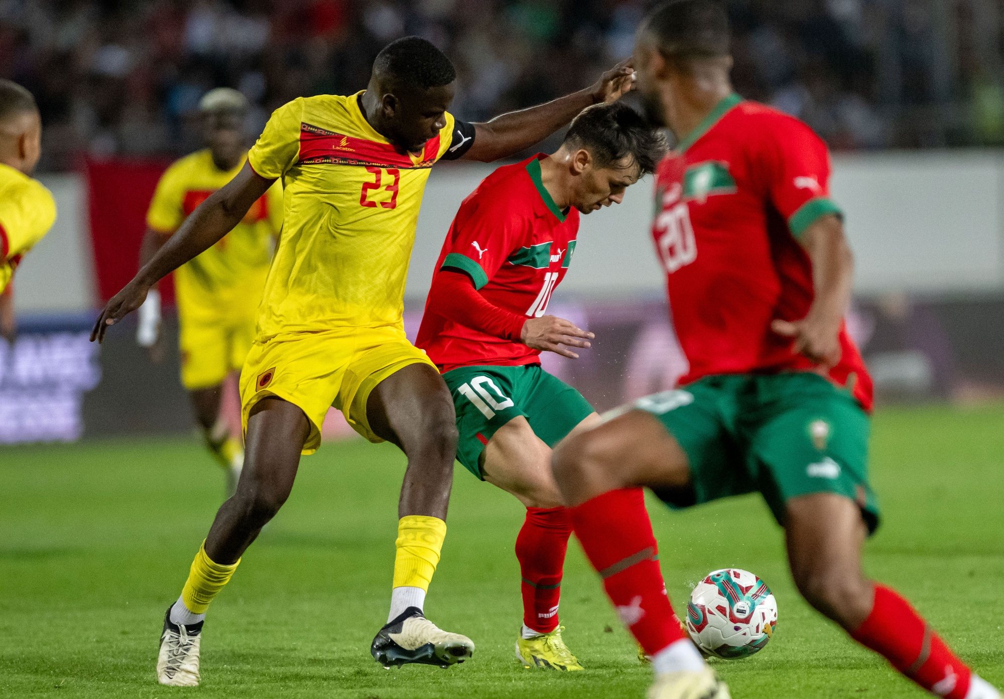 epa11237692 Brahim Diaz (C) of Morocco in action against Manuel &#039;Show&#039; Cafumana (L) of Angola during the friendly international soccer match between Morocco and Angola in Agadir, Morocco, 22 March 2024.  EPA/JALAL MORCHIDI