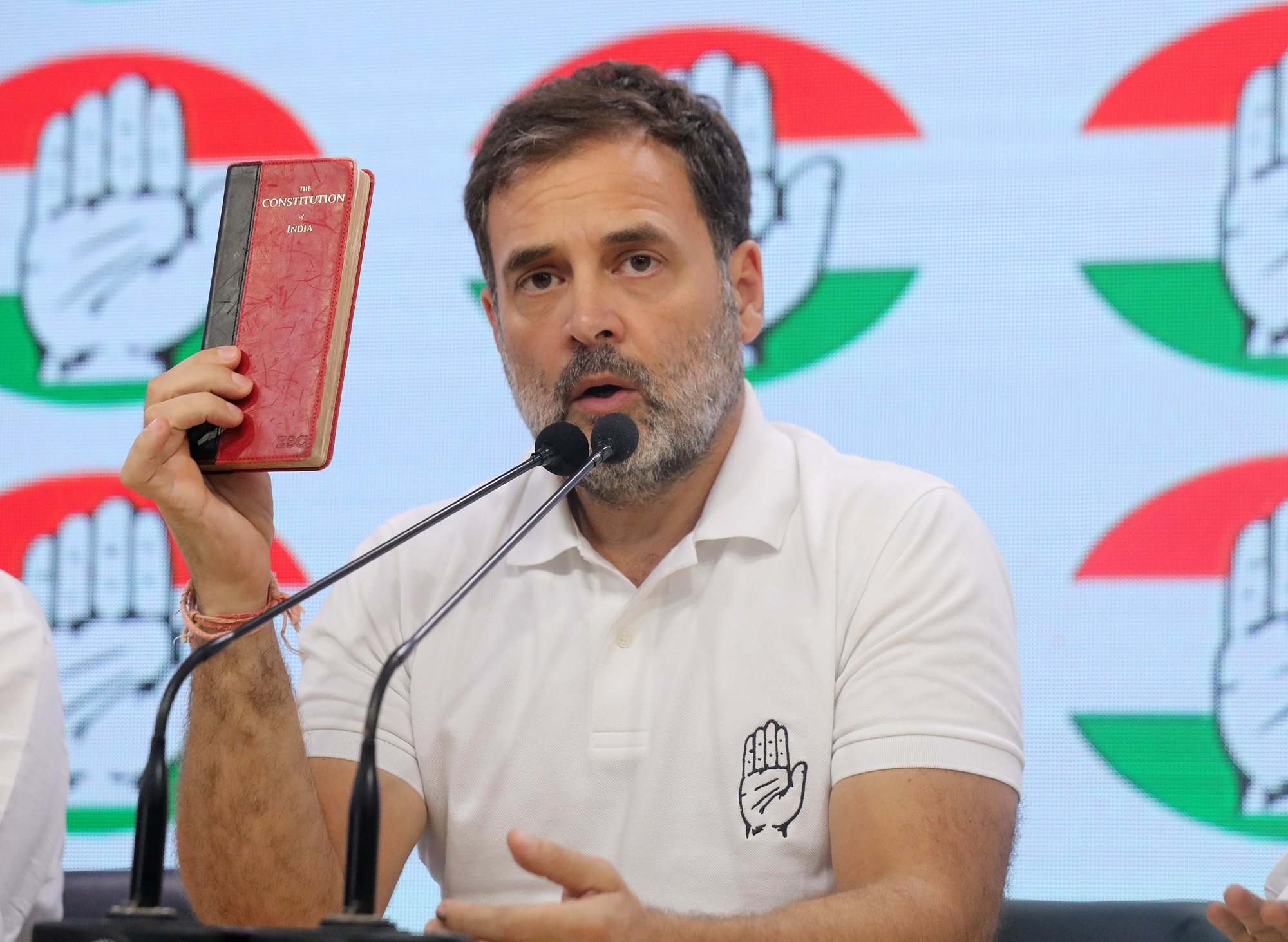 epa11390006 Indian National Congress Party senior leader Rahul Gandhi holds a copy of the Indian constitution as he speaks during a press conference at Congress headquarters in New Delhi, India, 04 June 2024. Bharatiya Janata Party (BJP) leader and Indian Prime Minister Narendra Modi claimed victory in the 2024 India elections which started on 19 April. The Lok Sabha elections were held for 545 lower house seats, and a party or alliance needs 272 seats to form a government.  EPA/RAJAT GUPTA