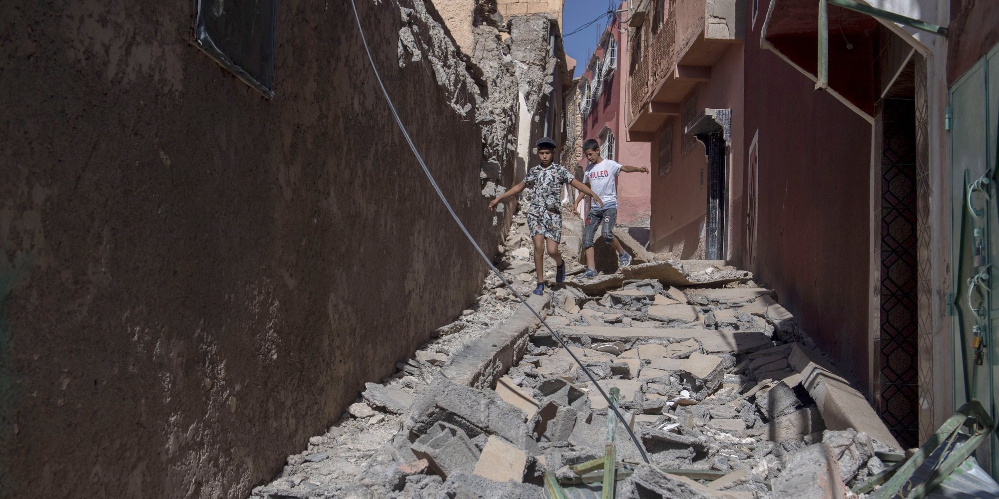epa10850133 Two children walk among debris of damaged buildings following an earthquake in Marrakesh, Morocco, 09 September 2023. A powerful earthquake that hit central Morocco late 08 September, killed at least 820 people and injured 672 others, according to a provisional report from the country&#039;s Interior Ministry. The earthquake, measuring magnitude 6.8 according to the USGS, damaged buildings from villages and towns in the Atlas Mountains to Marrakesh.  EPA/JALAL MORCHIDI