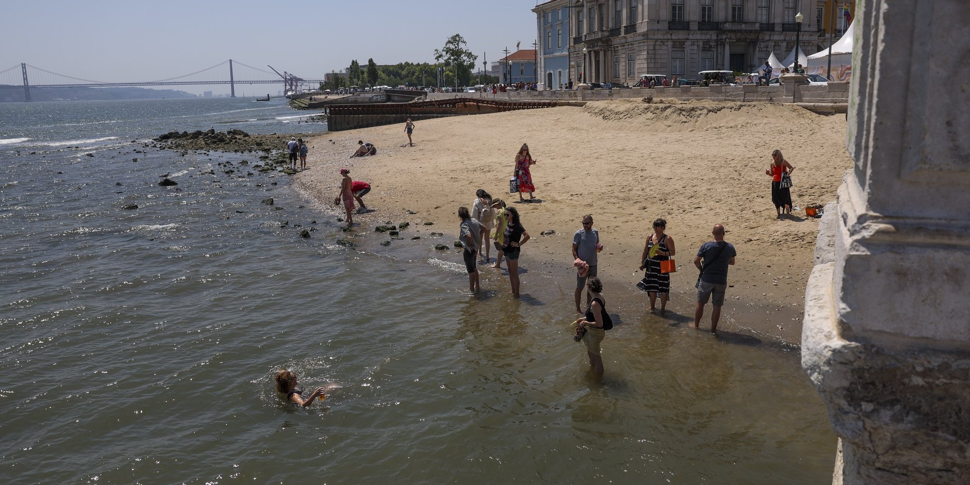 Turistas refrescam-se na água do Rio Tejo, junto ao Cais das Colunas, em Lisboa, 24 de junho de 2023. Segundo o Instituto do Mar e da Atmosfera (IPMA), as temperaturas poderão chegar aos 40 graus em várias zonas do país até à próxima quinta-feira, dia 29 de junho. JOSÉ SENA GOULÃO/LUSA