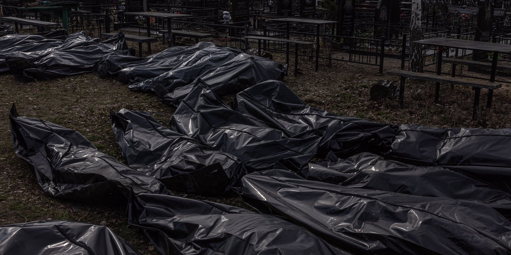 epa09877034 Bodies of killed people, which were brought to the cemetery, lay on the ground in body bags, in Bucha, northwest of Kyiv, Ukraine, 07 April 2022. Hundreds of tortured and killed civilians have been found in Bucha and other parts of the Kyiv region after the Russian army retreated from those areas. The growing evidence shows that the Russian forces are believed to be behind the atrocities when they were controlling the areas. Russian troops entered Ukraine on 24 February resulting in fighting and destruction in the country and triggering a series of severe economic sanctions on Russia by Western countries.  EPA/ROMAN PILIPEY