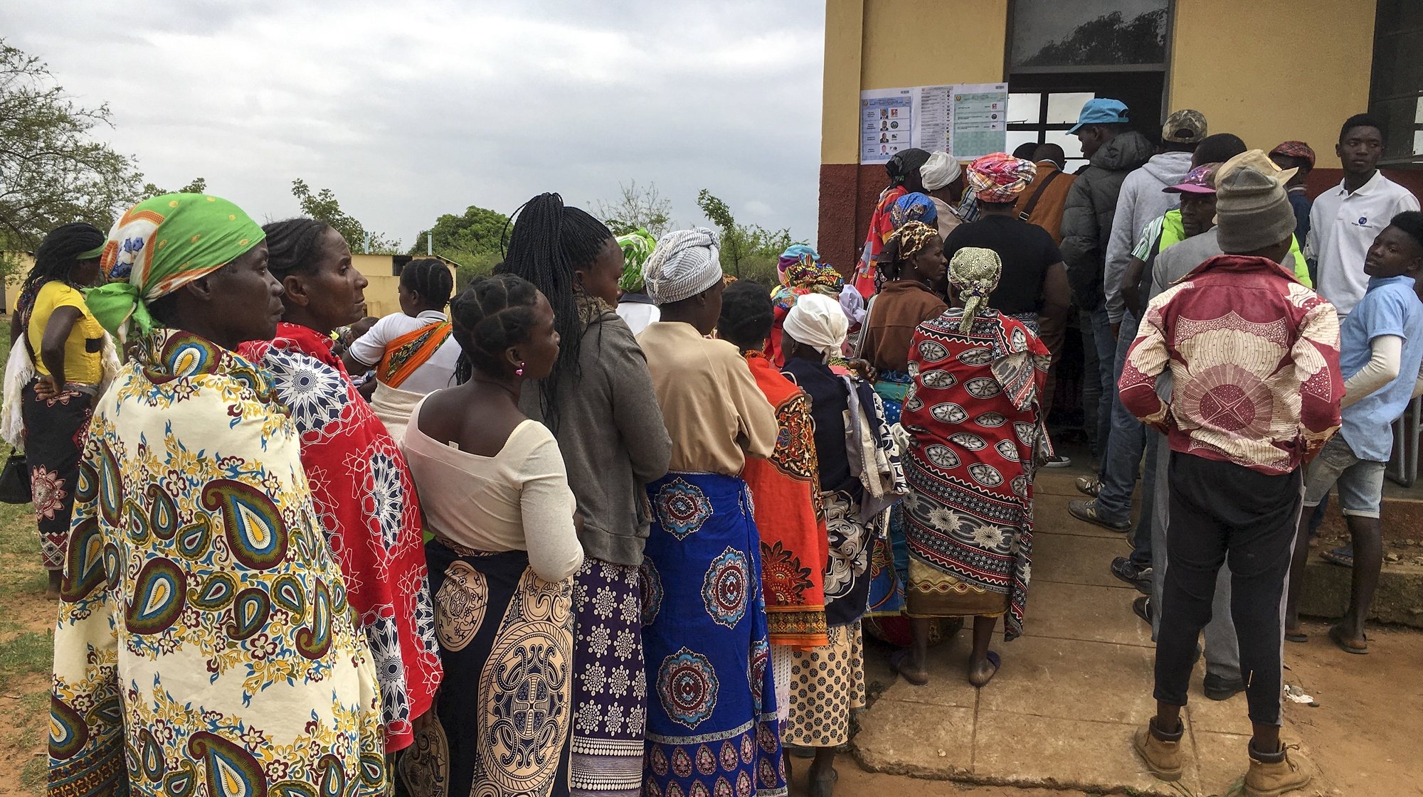 epa07921898 People wait in line prior to vote outside a polling station in Chimoio, Manica Province, Mozambique, 15 October 2019. Some 12.9 million Mozambican voters will choose the President of the Republic, ten provincial assemblies and their governors, as well as 250 members of the Assembly of the Republic.  EPA/ANDRE CATUEIRA