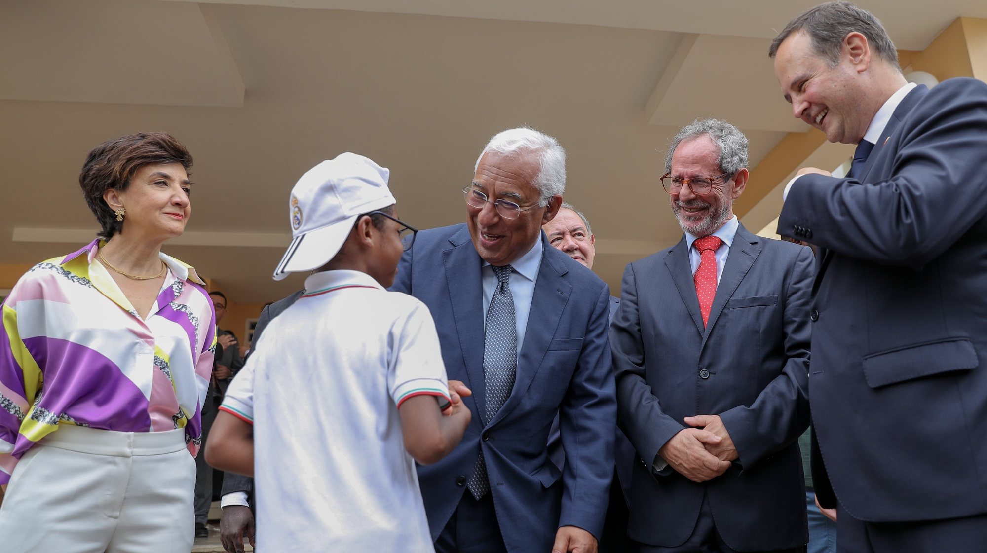 Portugal&#039;s Prime Minister Antonio Costa (C), accompanied by Portuguese Ministers for Agriculture and Food of Economy and Sea Maria do Ceu Antunes (L), of Economy and Sea Antonio Costa Silva (3-R), and the Finance Fernando Medina (R), greets a student during the visit to the Portuguese school in Luanda, Angola, 06 June 2023. AMPE ROGERIO/LUSA