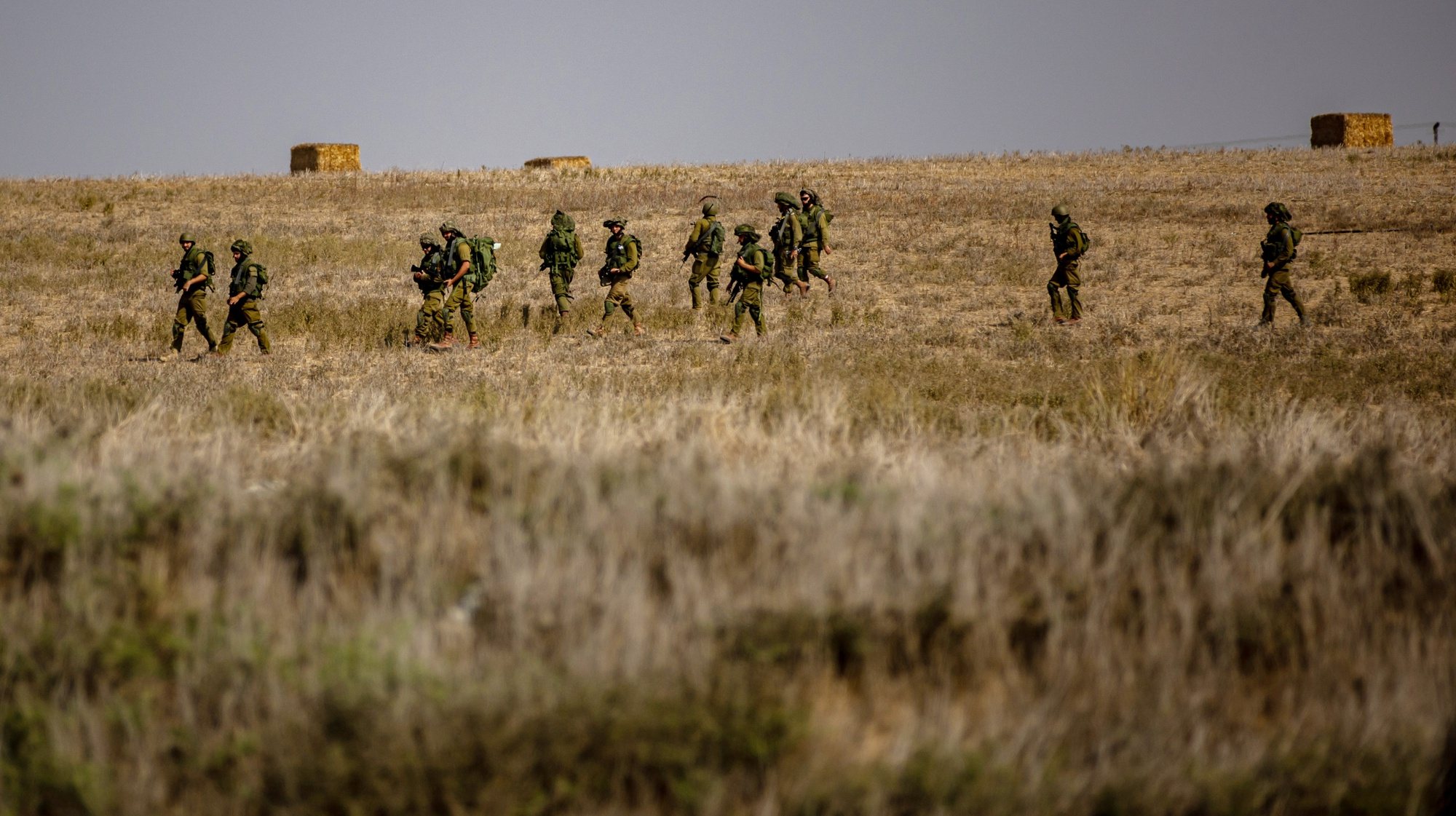 epa10912972 Israeli soldiers move through a field at an area along the border with Gaza, southern Israel, 11 October 2023. More than 1,200 Israelis have been killed and over 2,800 others injured, according to the Israel Defense Forces (IDF), after the Islamist movement Hamas launched an attack against Israel from the Gaza Strip on 07 October. More than 3,000 people, including 1,500 militants from Hamas, have been killed and thousands injured in both Gaza and Israel since the conflict erupted, according to Israeli military sources and Palestinian officials.  EPA/MARTIN DIVISEK