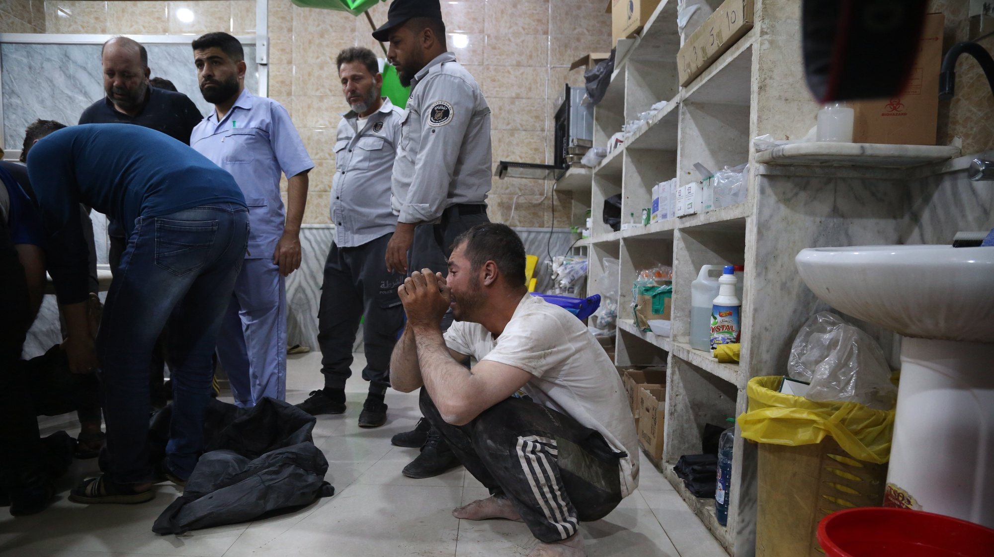 epa10903684 A man cries as medics attend to a victim at Kenana Hospital following an attack on Darat Izza city in north-western Aleppo, Syria, 05 October 2023 (issued 06 October 2023). According to the UK-based Syrian Observatory for Human Rights (SOHR), at least 13 people were killed in attacks reportedly carried by Syrian forces targeting Idlib and Aleppo. Four people were killed and seven others injured in heavy artillery fire by regime forces targeting positions in Darat Izza city in north-western Aleppo, SOHR said.  EPA/BILAL AL-HAMMOUD
