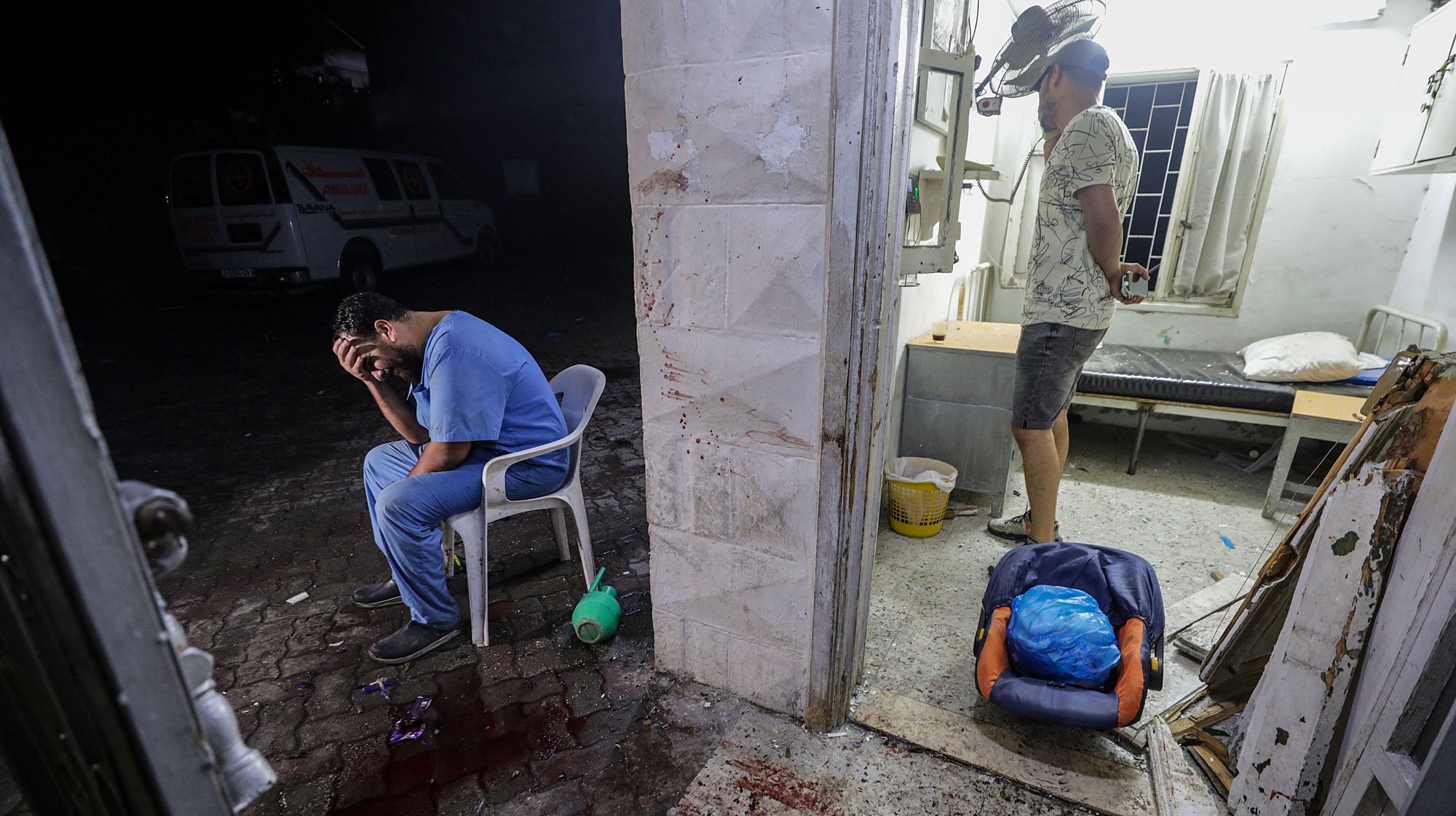 epa10962784 A doctor at the scene of Al Ahli hospital after an explosion in Gaza City, 17 October 2023.  (Issued 07 November 2023). 07 November 2023, marks one month since Hamas militants launched an attack against Israel from the Gaza Strip, which was followed by Israeli operations in Gaza and the West Bank. More than 10,000 Palestinians and at least 1,400 Israelis have been killed and more than 200 others were taken hostage by Hamas militants, according to the Palestinian health authority and  the Israel Defense Forces (IDF).  EPA/MOHAMMED SABER  ATTENTION: This Image is part of a PHOTO SET