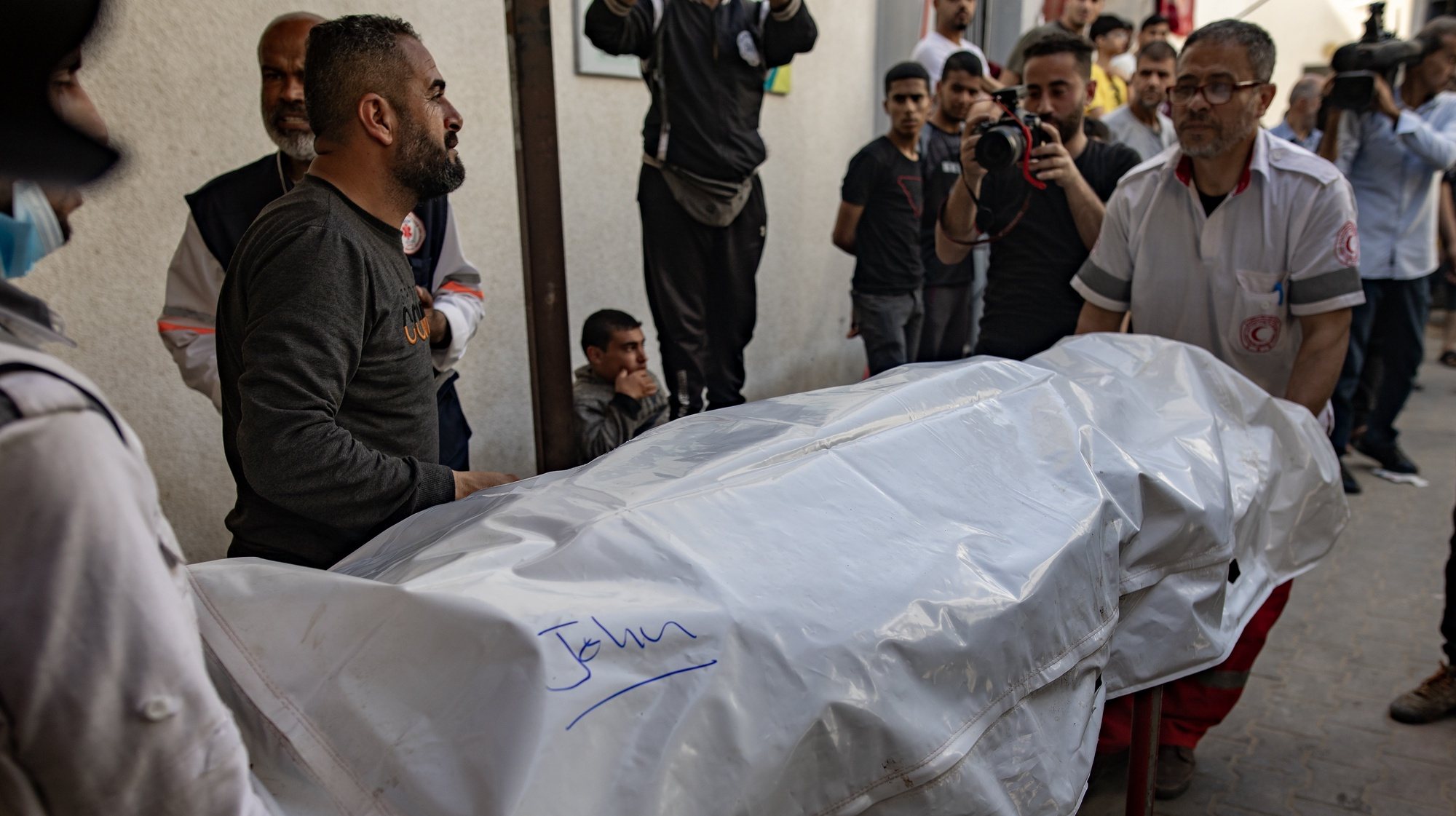 epa11256882 World Central Kitchen workers move the bodies of their colleagues from Al-Najjar Hospital to the Rafah crossing for expatriation, 03 April 2024. The bodies of six foreign aid workers killed in a Gaza strike are to be transported out via Egypt.  EPA/HAITHAM IMAD