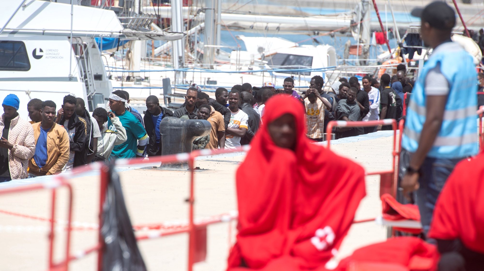 epa11329552 Rescued migrants rest at the port of Gran Tarajal, slas Canarias, Spain, 09 May 2024. Maritime Rescue has rescued 112 migrants of sub-Saharan origin who were trying to reach Fuerteventura in two inflatable boats, including three women and a child.  EPA/Carlos de Saa