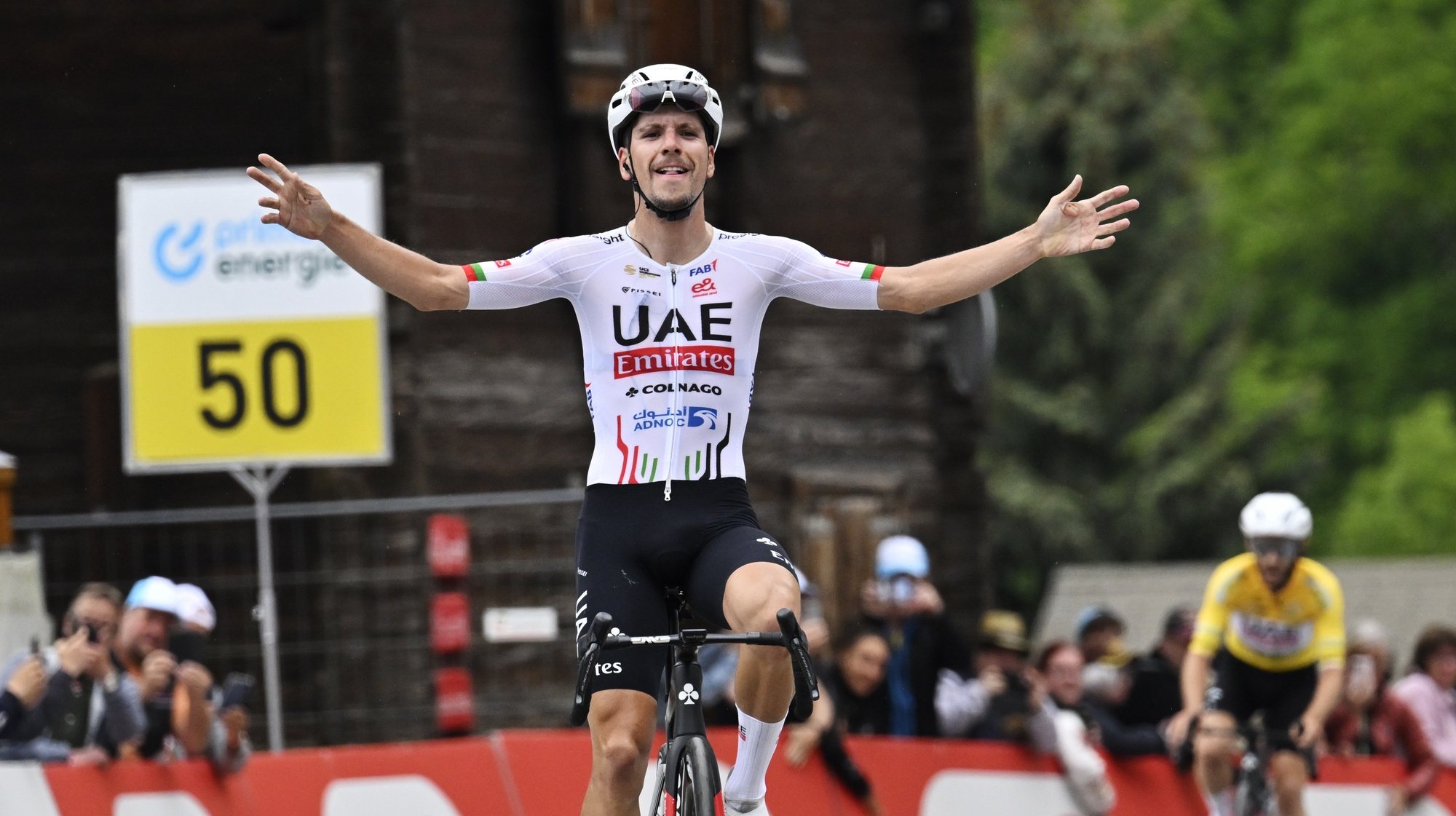 epa11409751 UAE Team Emirates rider Joao Almeida of Portugal celebrates winning the sixth stage of the Tour de Suisse, a 42.5km cycling race from Ulrichen to Blatten-Belalp, Switzerland, 14 June 2024.  EPA/GIAN EHRENZELLER