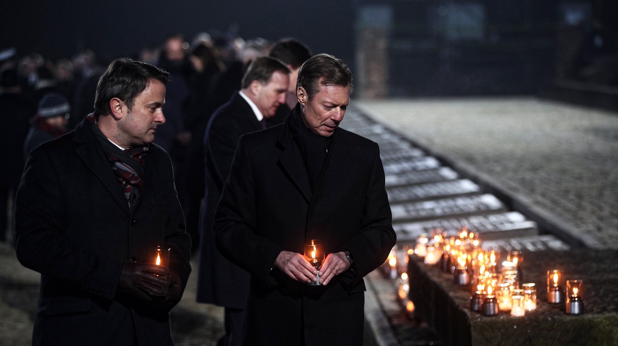 epa08170451 Grand Duke Henry of Luxembourg (R) and Prime Minister of Luxembourg Xavier Bettel (L) light candles at the International Monument to the Victims of Fascism the main commemoration ceremony at the former Auschwitz II-Birkenau camp during ceremonies marking the 75th anniversary of the liberation of the former Nazi-German concentration and extermination camp KL Auschwitz-Birkenau, in Oswiecim, Poland, 27 January 2020. The biggest German Nazi death camp KL Auschwitz-Birkenau was liberated by the Soviet Red Army on 27 January 1945. The world commemorates its liberation by International Holocaust Remembrance Day annually on 27 January.  EPA/LUKASZ GAGULSKI POLAND OUT