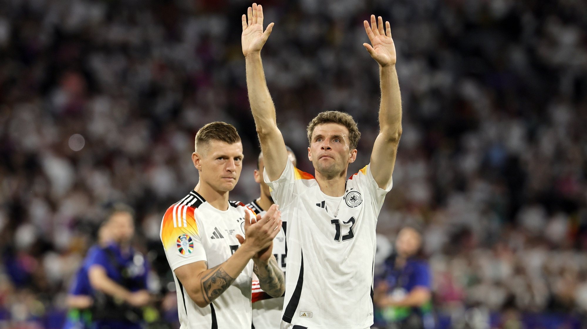 epa11411136 Toni Kroos (L) and Thomas Muller of Germany greet supporters after winning the UEFA EURO 2024 group A match between Germany and Scotland in Munich, Germany, 14 June 2024.  EPA/RONALD WITTEK