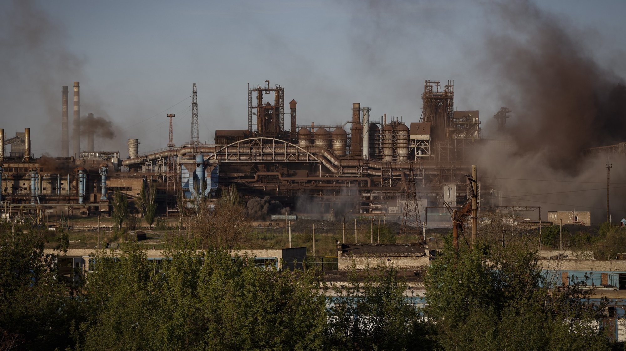 epa09932619 Smoke rises over Azovstal steel plant in Mariupol, Ukraine, 07 May 2022. According to the Interdepartmental Coordinating Headquarters of the Russian Federation for Humanitarian Response, 51 civilians, including 11 children, were evacuated from the Azovstal plant between 05 and 07 May. On 24 February, Russian troops had entered Ukrainian territory in what the Russian president declared a &#039;special military operation&#039;, resulting in fighting and destruction in the country. According to data released by the United Nations High Commission for the Refugees (UNHCR) on 05 May, over 5.7 million refugees have fled Ukraine seeking safety, protection and assistance in neighboring countries.  EPA/ALESSANDRO GUERRA