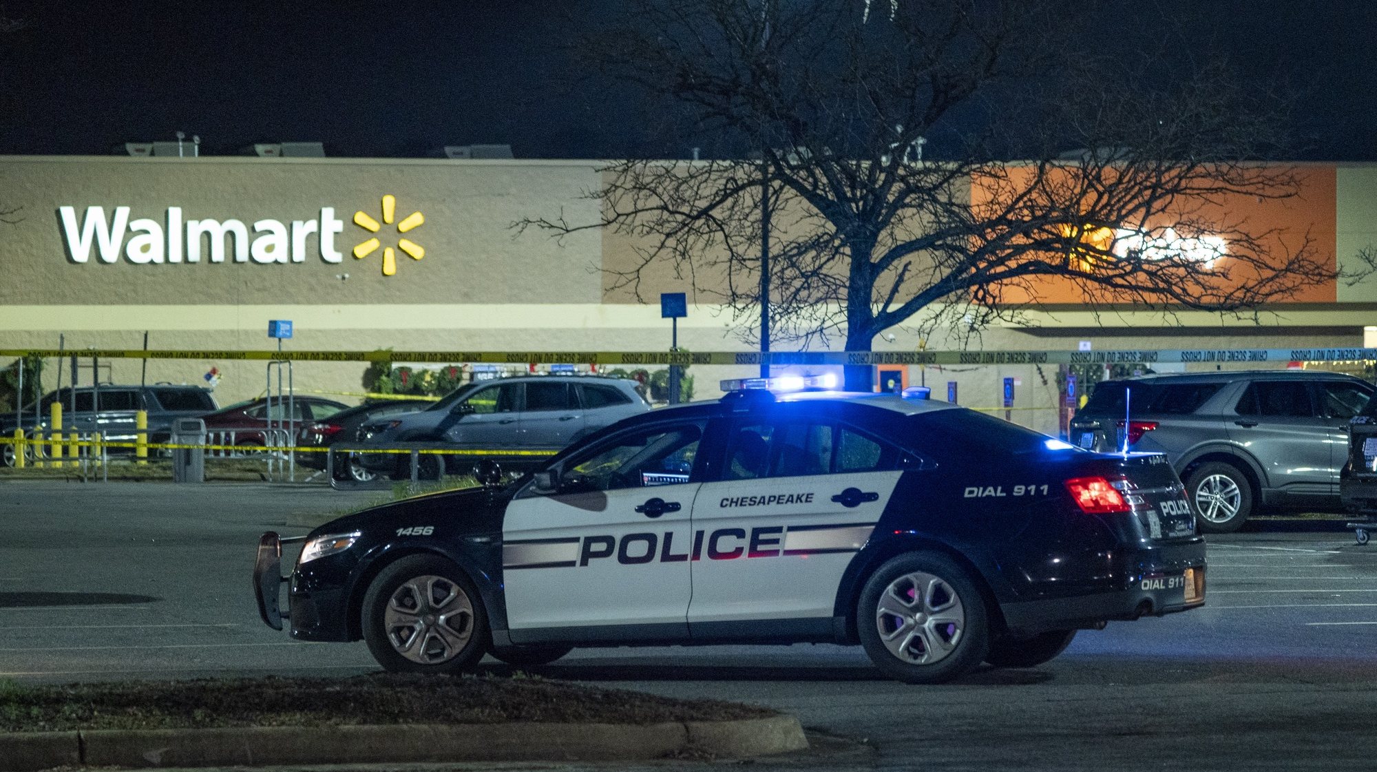 epa10322072 Police officers work at the scene of a mass shooting at the Walmart Supercenter in Chesapeake, Virginia, USA, 23 November 2022. Leo Kosinski of the Chesapeake Police Department said officers responded to a report of a shooting at around 10:15 pm 22 November 2022. At least seven people including the shooter died in the shooting, police said.  EPA/SHAWN THEW