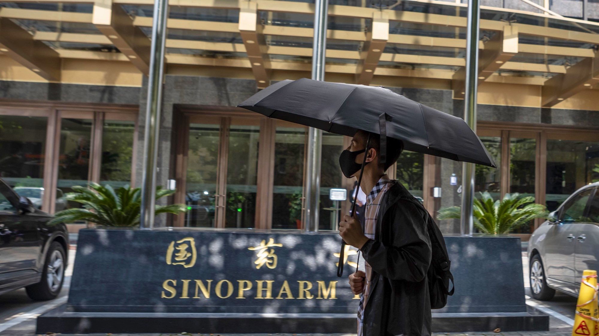 epa08628128 A man walks in front of the Sinopharm headquarters in Shanghai, China, 25 August 2020 (issued 27 August 2020). According to media reports, Sinopharm, major state-owned Chinese pharmaceutical company, plans to have a COVID-19 vaccine on the market by the end of 2020.  EPA/ALEX PLAVEVSKI