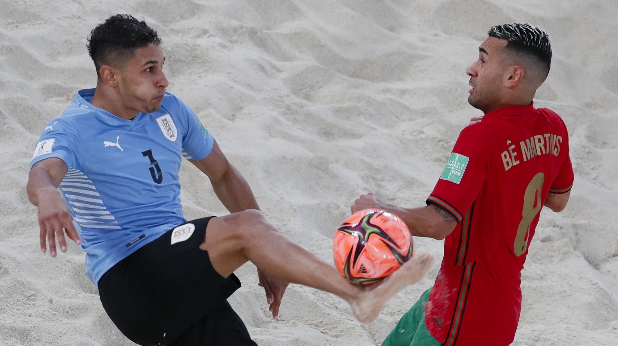 epa09427902 Matias Guerrero (L) of Uruguay in action against Be Martins of Portugal during the FIFA Beach Soccer World Cup 2021 match between Portugal and Uruguay at Luzhniki Beach Soccer Stadium in Moscow, Russia 24 August 2021.  EPA/YURI KOCHETKOV