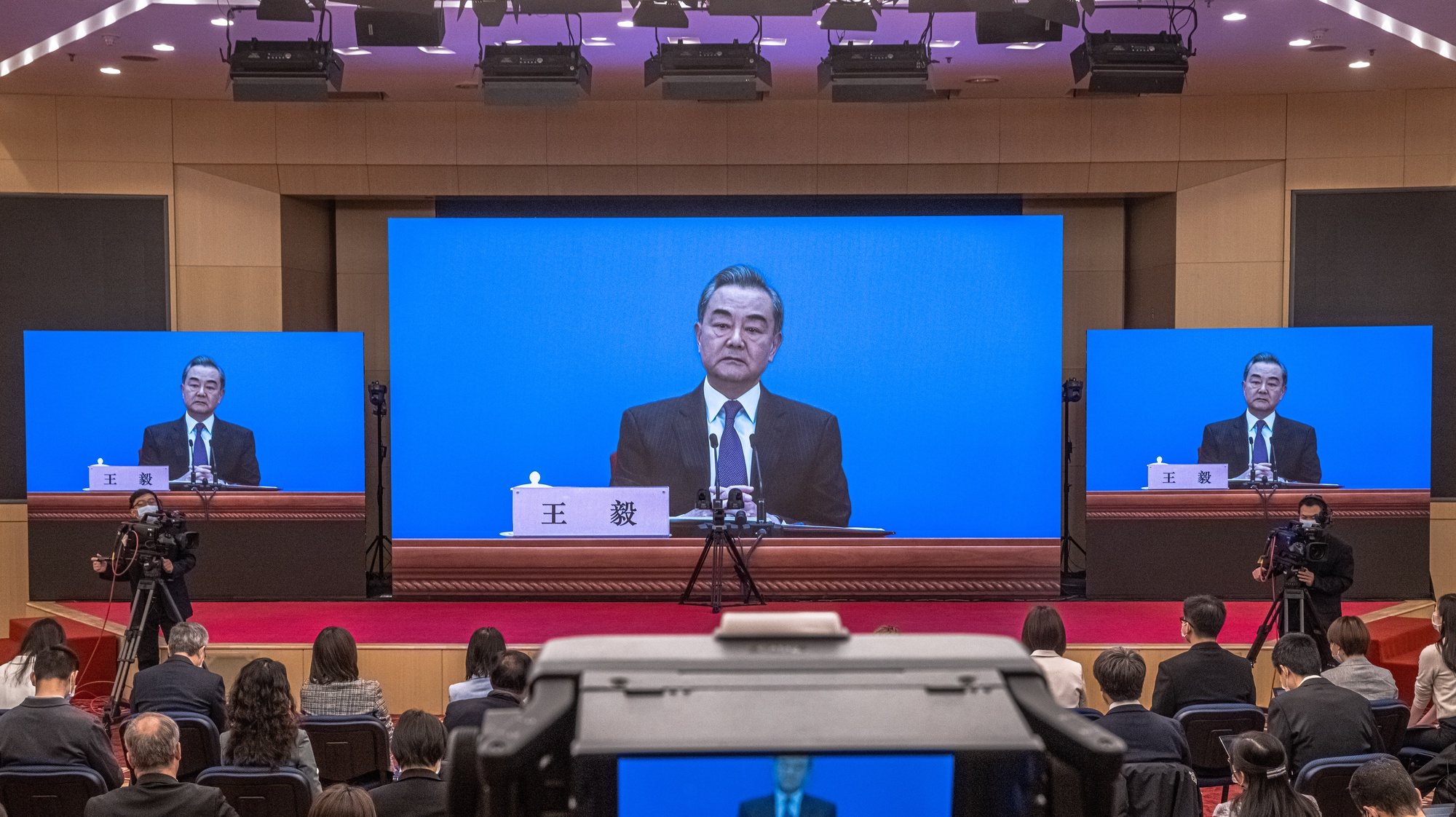 epa09058456 Chinese Foreign Minister Wang Yi is seen on a screen as he speaks to reporters during an online press conference, in Beijing, China, 07 March 2021. China holds two major annual political meetings, The National People’s Congress (NPC) and the Chinese People&#039;s Political Consultative Conference (CPPCC) which run alongside and together known as &#039;Lianghui&#039; or &#039;Two Sessions&#039;.  EPA/ROMAN PILIPEY