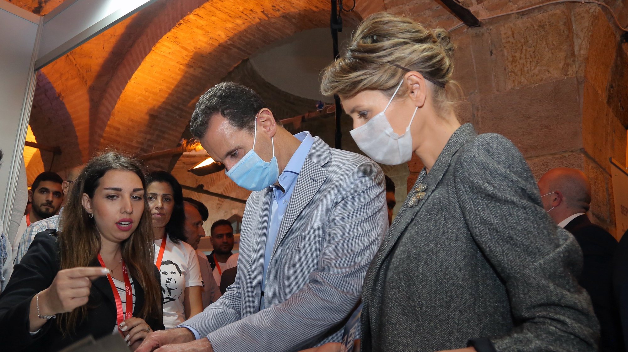epa08799119 A handout photo made available by the official Syrian Arab News Agency (SANA) shows Syrian President Bashar al-Assad and his wife Asma Assad touring the various sections of the 5-day exhibition Producers 2020 in Tekkiye Sulaymaniya in Damascus, Syria, 04 October 2020. The exhibition is held with the participation of 77 producers from the northern city of Aleppo.  EPA/SANA /HANDOUT  HANDOUT EDITORIAL USE ONLY/NO SALES
