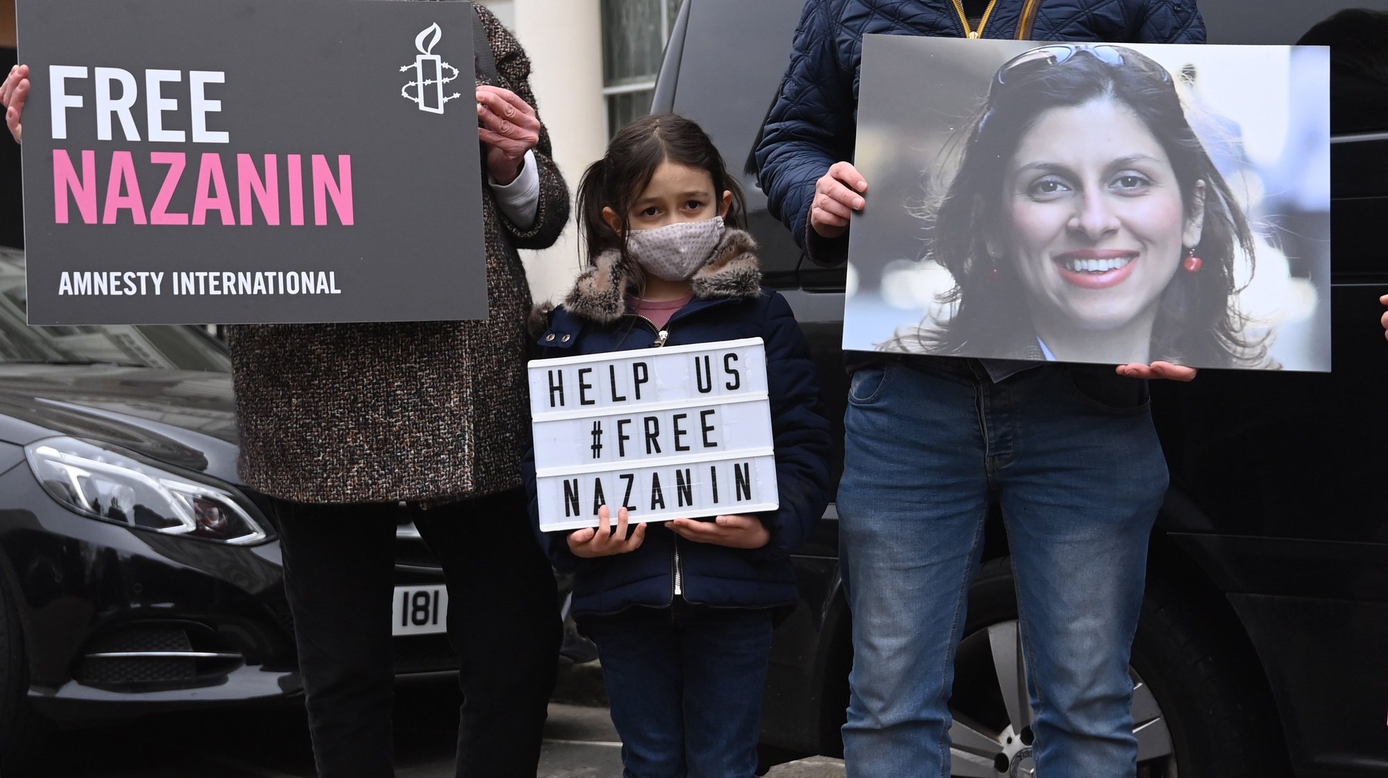 epa09061576 Nazanin Zaghari-Ratcliffe&#039;s daughter Gabriella protests outside the Iranian Embassy in London, Britain, 08 March 2021. Nazanin Zaghari-Ratcliffe was due to be released on 07 March after serving a five year jail term in Iran for alleged spying, a claim which she denies.  EPA/FACUNDO ARRIZABALAGA