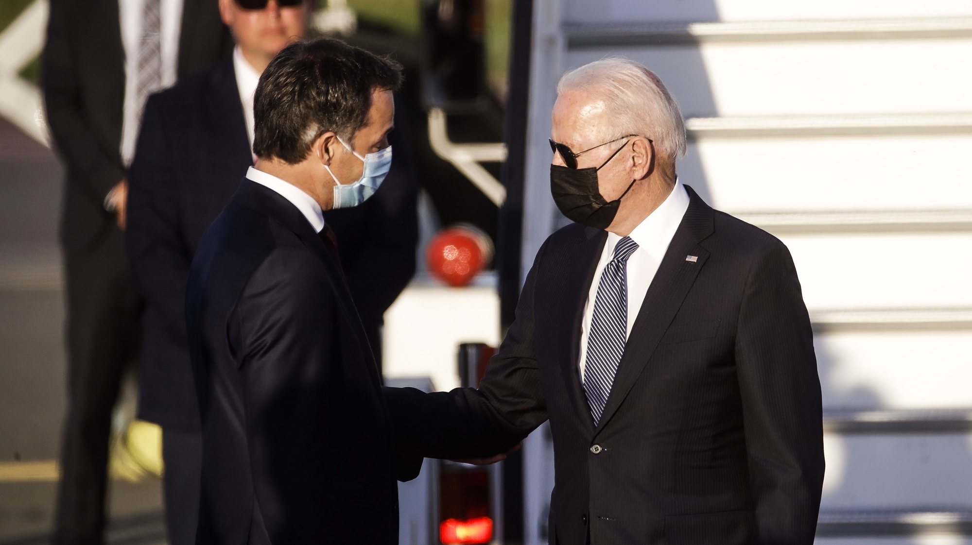 epa09268618 Belgium Prime Minister Alexander De Croo (L) welcomes US President Joe Biden (R) upon arrival at Brussels Military Airport, in Melsbroek, Belgium, 13 June 2021. US President Biden is in Brussels for two days of NATO Summit and EU-US summit on 14 and 15 June.  EPA/OLIVIER HOSLET / POOL