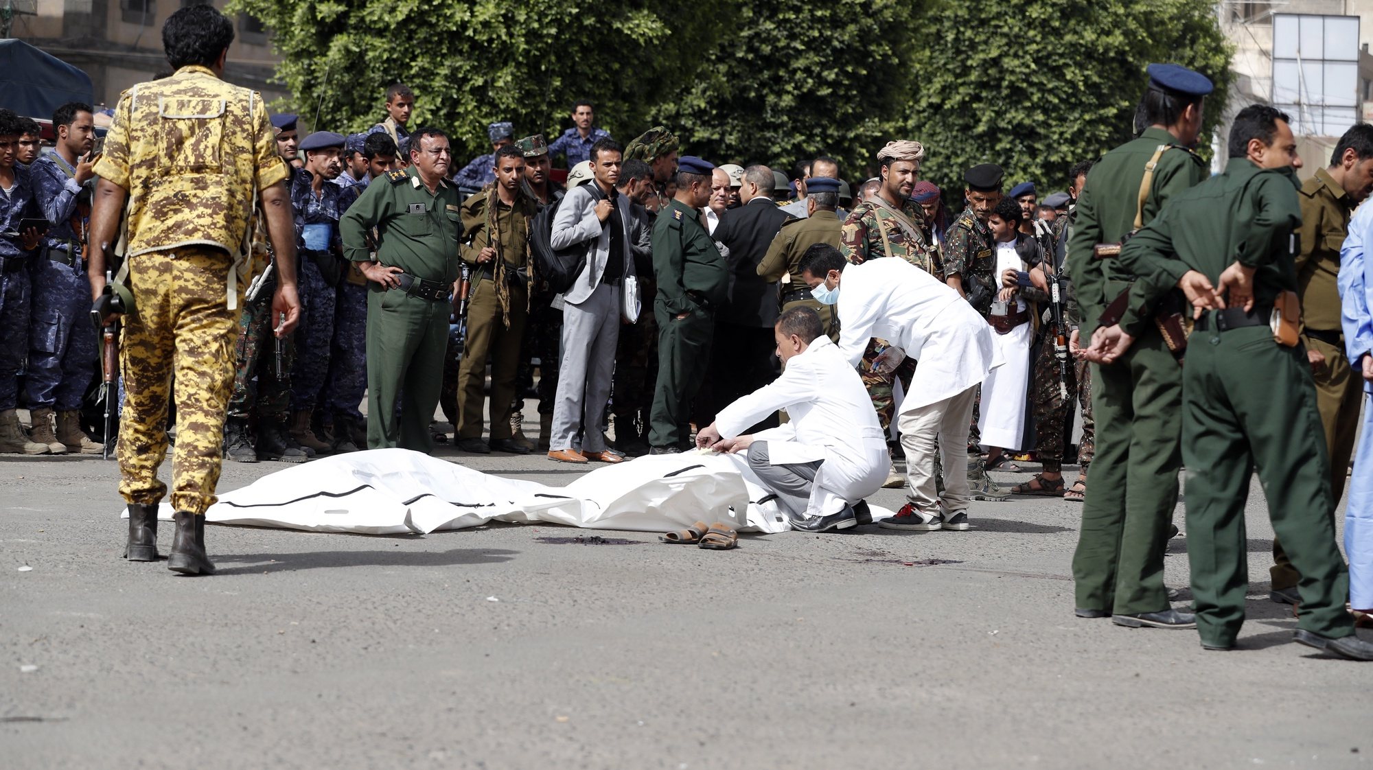 epa09275416 Soldiers wrap the bodies of Abdullah Al-Makhali and Mohammed Arman, convicted of raping and murdering a boy, after they were shot dead at a public square in Sana&#039;a, Yemen, 16 June 2021. Defendants Abdullah Al-Makhali, 38, and Mohammed Arman, 33, convicted of raping and killing boy Mohammed al-Haddad, were executed at a public square in the Yemeni capital Sana&#039;a.  EPA/YAHYA ARHAB