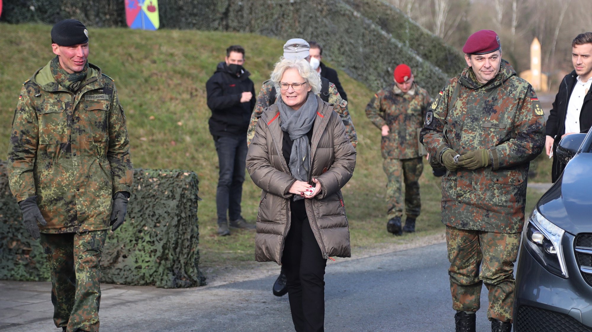 epa09735142 The German Minister of Defense Christine Lambrecht (C) with the commander of the 9th Panzerlehr Brigade Christian Freuding during her visit at the 9th Panzerlehr Brigade of the German Bundeswehr in Munster, northern Germany, 07 February 2022. At the moment, 200 soldiers of the 9th Panzerlehr Brigade take part in the NATO mission enhanced Forward Presence (eFP) in Lithuania.  EPA/FOCKE STRANGMANN