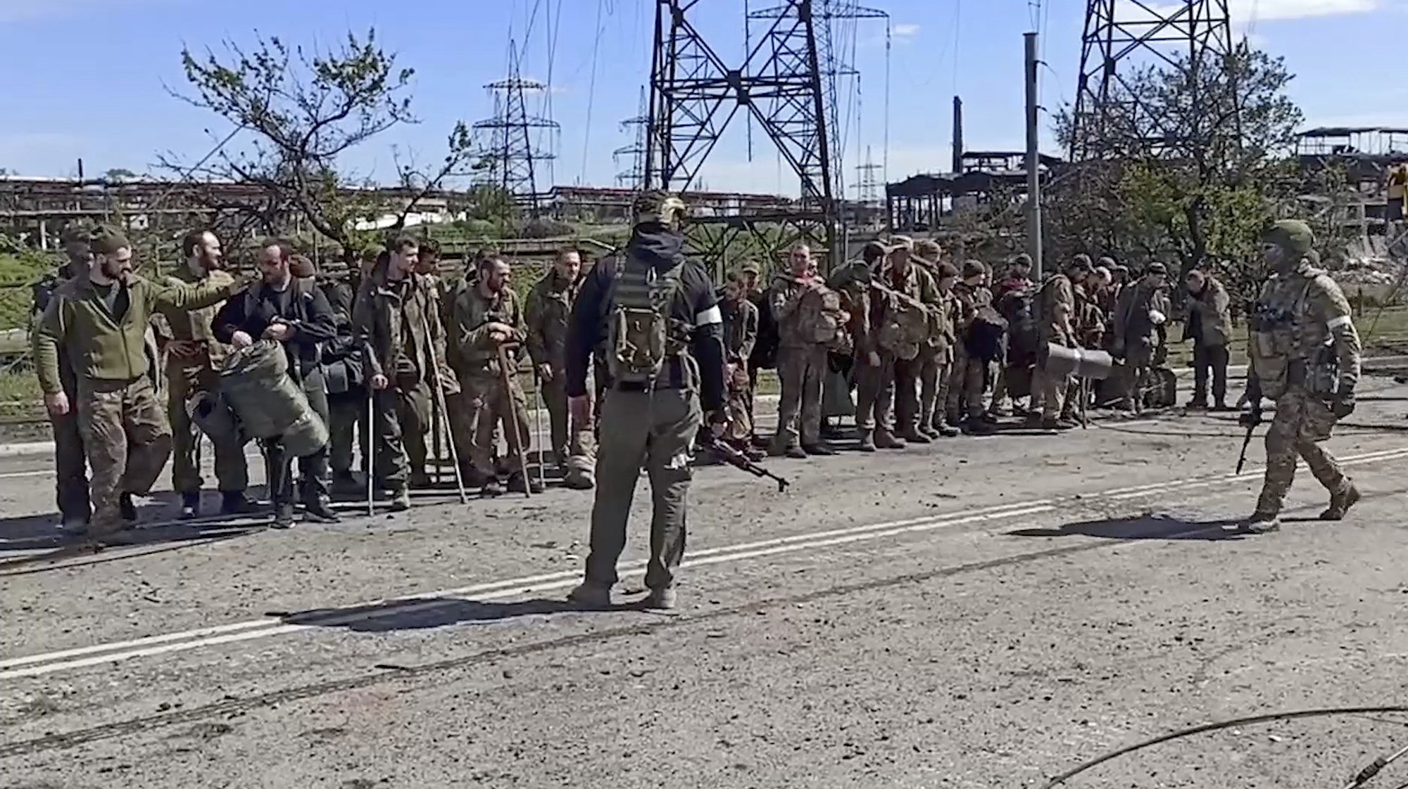 epa09956598 A still image taken from a handout video dated 17 Apirl 2022 and made available by the Russian Defence ministry press service on 18 April 2022 shows Ukrainian servicemen (facing) from the besieged Azovstal steel plant preparing to be evacuated, Mariupol, Ukraine, 17 May 2022. A total of 265 Ukrainian militants, including 51 seriously wounded, have laid down arms and surrendered to Russian forces, the Russian Ministry of Defence said on 17 May 2022. Those in need of medical assistance were sent for treatment to a hospital in Novoazovsk, the ministry states further. Russian President Putin on 21 April 2022 ordered his Defence Minister to not storm but to blockade the plant where a number of Ukrainian fighters were holding out. On 24 February, Russian troops invaded Ukrainian territory starting a conflict that has provoked destruction and a humanitarian crisis. According to the UNHCR, more than six million refugees have fled Ukraine, and a further 7.7 million people have been displaced internally within Ukraine since.  EPA/RUSSIAN DEFENCE MINISTRY PRESS SERVICE/HANDOUT HANDOUT HANDOUT EDITORIAL USE ONLY/NO SALES HANDOUT EDITORIAL USE ONLY/NO SALES