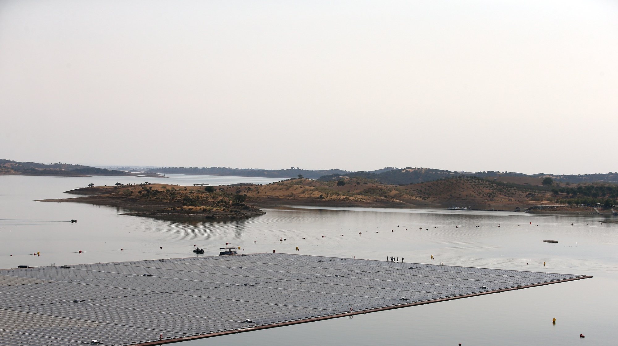 epa10072458 General view of the Solar Floating plant on the Alqueva dam wall at the River Guadiana, in Portel, eastern Portugal, 15 July 2022. The Floating Solar Power Plant of Alqueva, the largest floating solar park in a dam reservoir in Europe, an investment of six million euros, was inaugurated on 15 July by the Prime Minister, Antonio Costa.  EPA/NUNO VEIGA