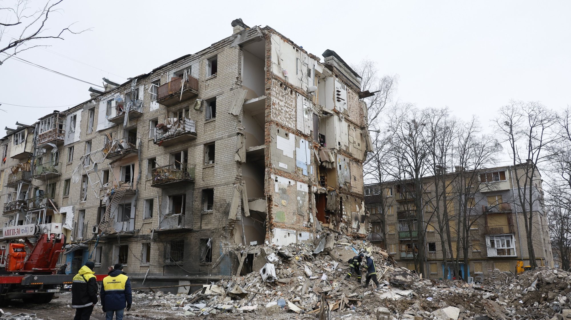 epa11101441 Ukrainian workers clean debris of damaged buildings on the site of a missile attack in Kharkiv, northeastern Ukraine, 24 January 2024, amid the Russian invasion. At least ten persons were killed and more than 60 were injured in Russian missile strikes in Kharkiv on 23 January, according to the State Emergency Service of Ukraine. Russian forces launched air strikes targeting Kyiv and Kharkiv on 23 January, Ukrainian authorities said.  EPA/SERGEY KOZLOV