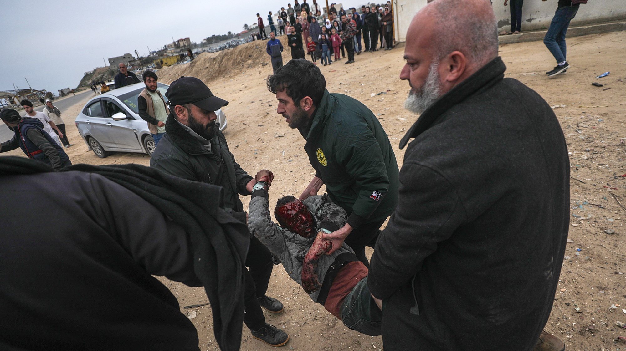epa11175442 Palestinians recover the wounded and the dead following an Israeli air strike in the west of Al Nusairat refugee camp, southern Gaza Strip, 23 February 2024. More than 29,500 Palestinians and over 1,300 Israelis have been killed, according to the Palestinian Health Ministry and the Israel Defense Forces (IDF), since Hamas militants launched an attack against Israel from the Gaza Strip on 07 October 2023, and the Israeli operations in Gaza and the West Bank which followed it.  EPA/MOHAMMED SABER ATTENTION EDITORS GRAPHIC CONTENT
