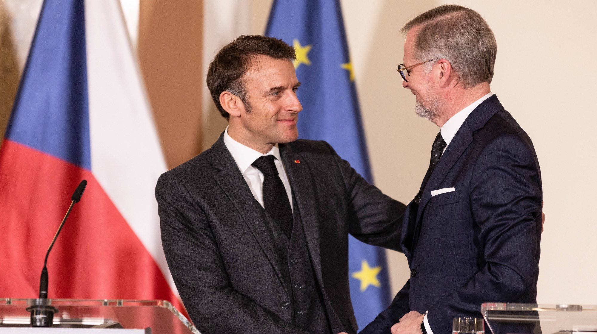 epa11200476 Czech Prime Minister Petr Fiala (R) shakes hands with French President Emmanuel Macron (L) during a press conference after their meeting in Prague, Czech Republic, 05 March 2024. Macron is on an official visit to Prague.  EPA/MICHAL TUREK