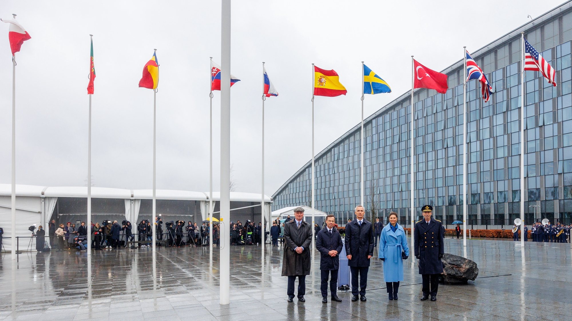 epa11214459 Crown Princess Victoria of Sweden, NATO Secretary General Jens Stoltenberg, and Swedish Prime Minister Ulf Kristersson attend the flag-raising ceremony to mark the accession of the Kingdom of Sweden to NATO at the Alliance headquarters in Brussels, Belgium, 11 March 2024.  EPA/OLIVIER MATTHYS