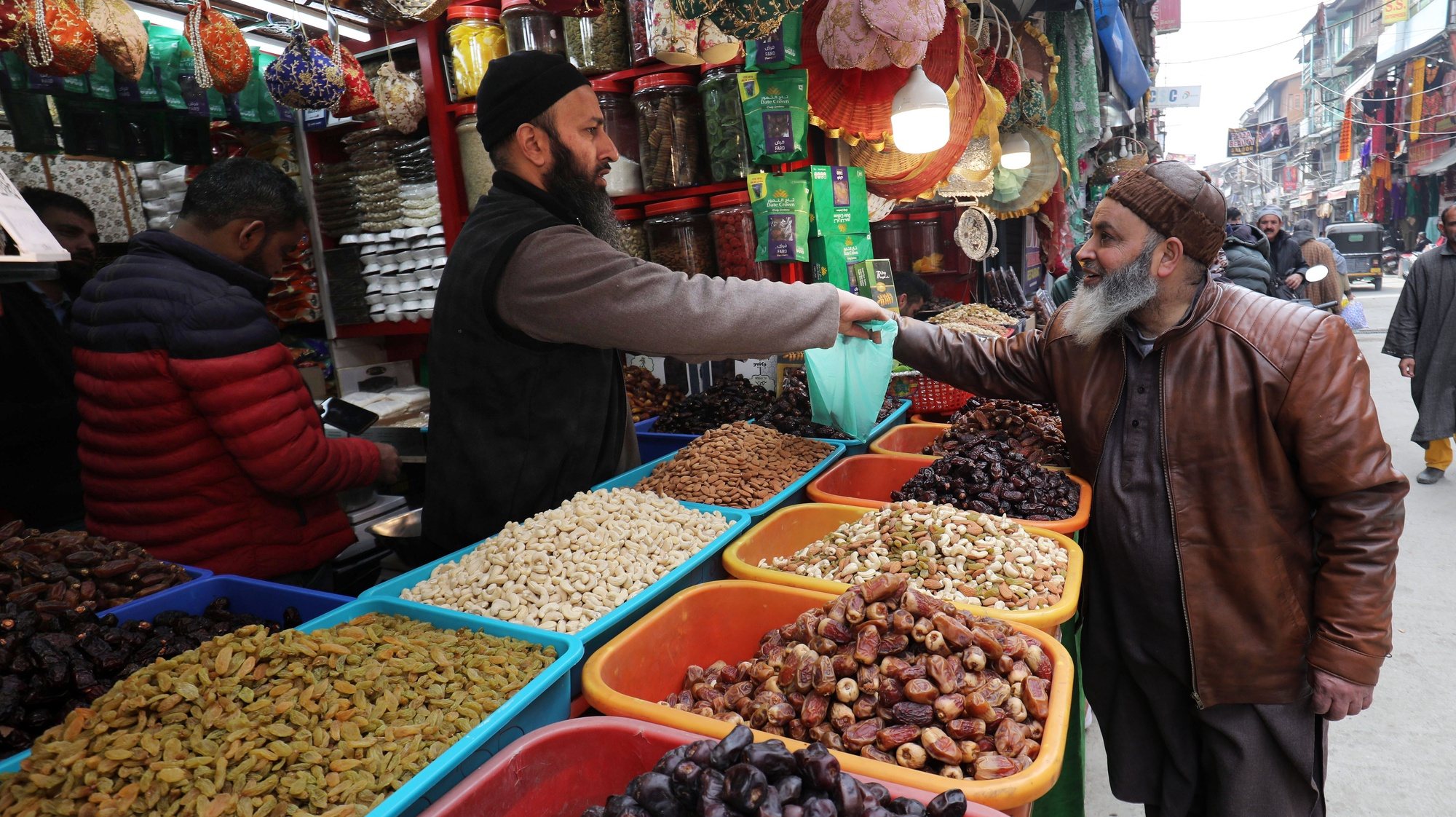 epa11214005 A Kashmiri Muslim man buys dry fruits ahead of the holy fasting month of Ramadan in Srinagar, the summer capital of Indian Kashmir, 11 March 2024. The Muslims&#039; holy month of Ramadan, which is expected to start on 12 March in Kashmir, is the ninth month in the Islamic calendar, and it is believed that the revelation of the first verse in the Koran was during its last 10 nights. It is celebrated yearly by praying during the night and abstaining from eating, drinking, and sexual acts during the period between sunrise and sunset. It is also a time for socializing, mainly in the evening after breaking the fast, and a shift of all activities to late in the day in most countries.  EPA/FAROOQ KHAN